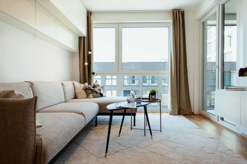 Sofa and coffee table facing large window