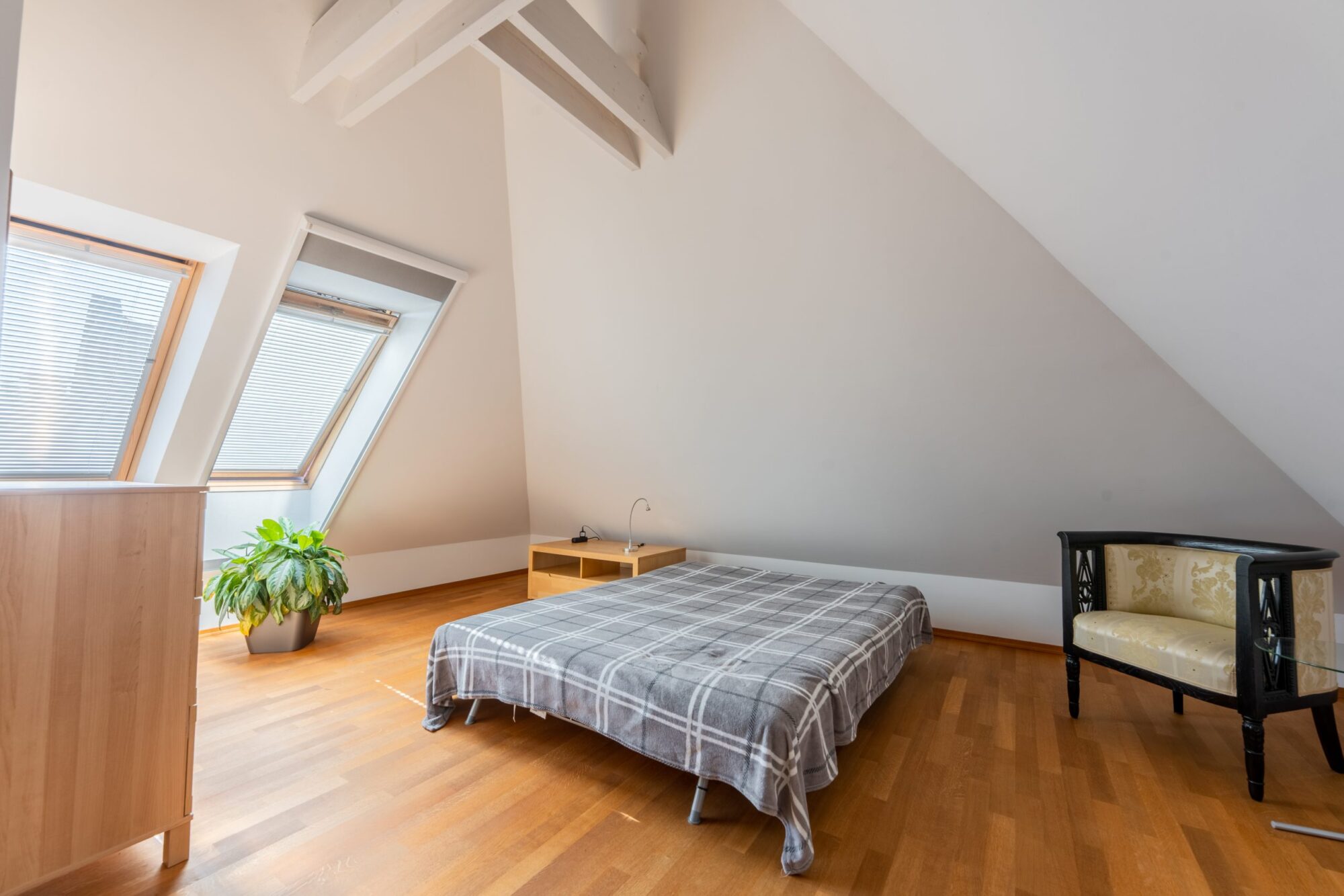 Attic bedroom with sloped ceiling and windows