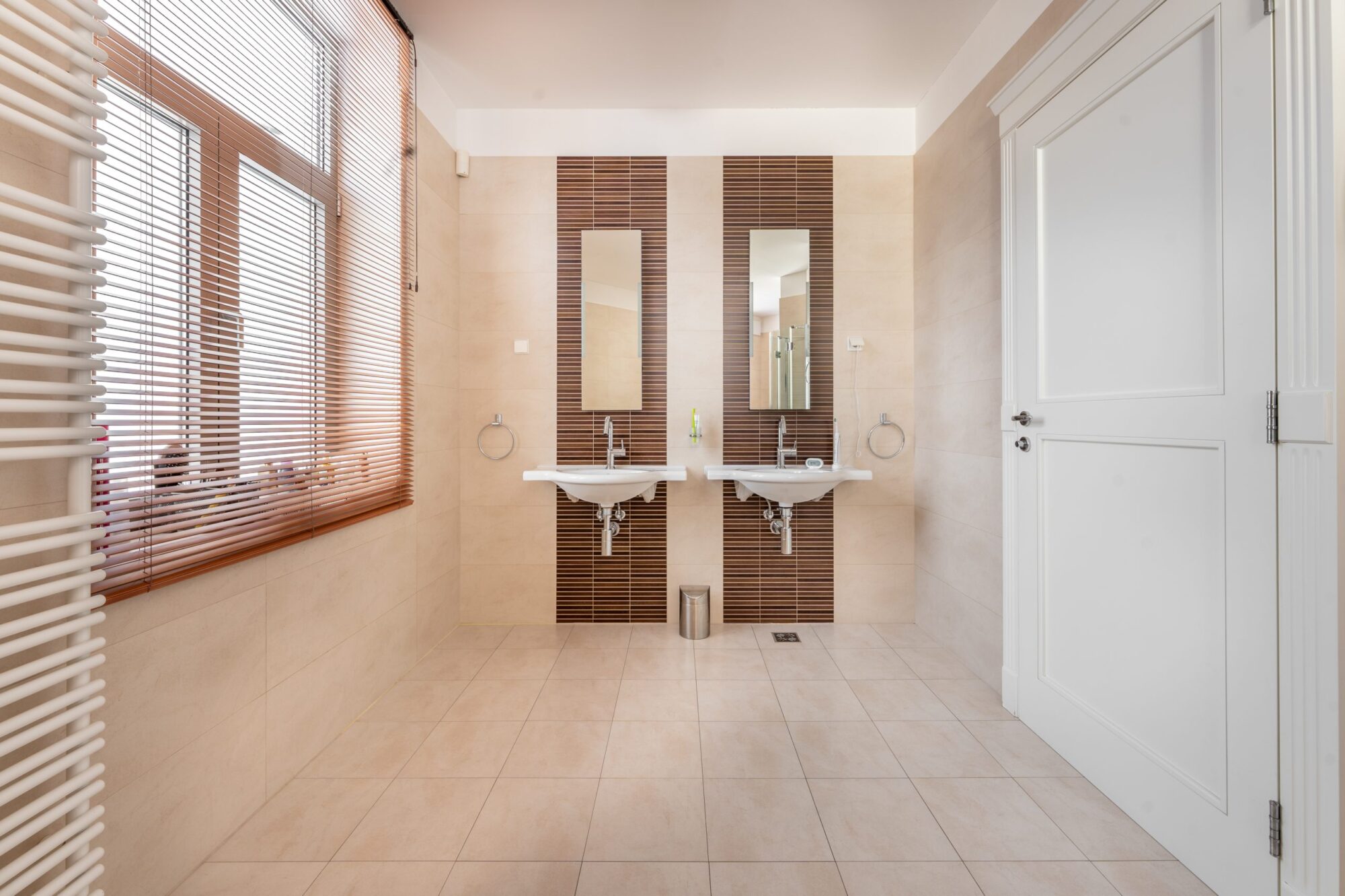 Bathroom with double sinks and mosaic tile accents