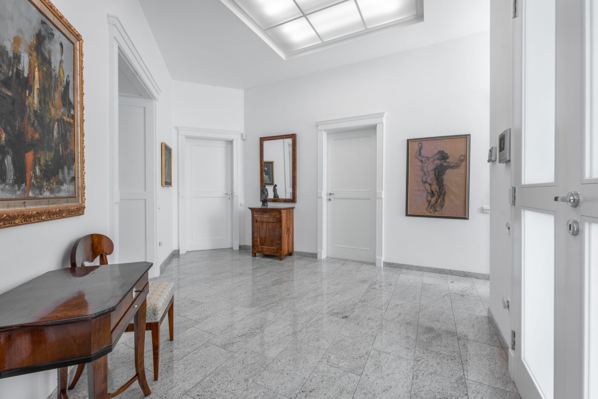 Marble hallway with antique furniture and art