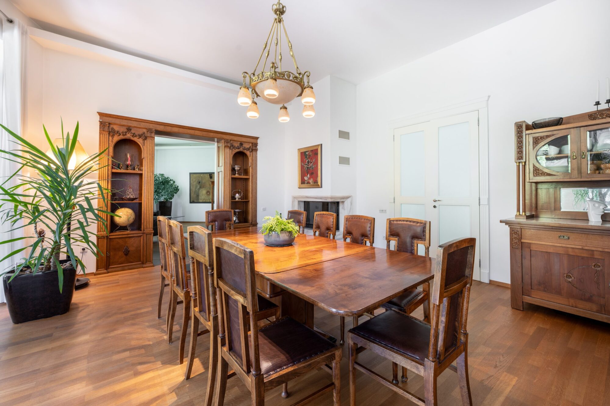 Elegant dining room with wooden table and antique cabinets