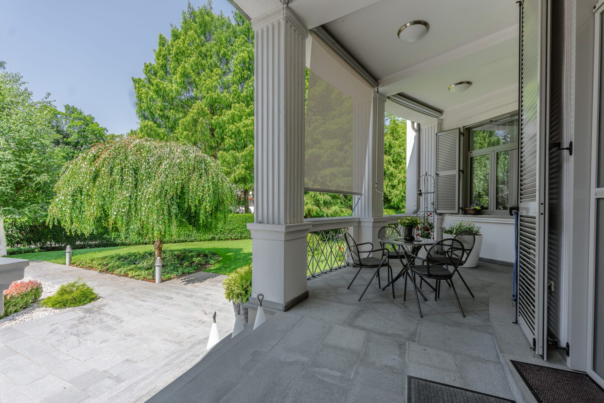 Covered patio with columns and outdoor seating