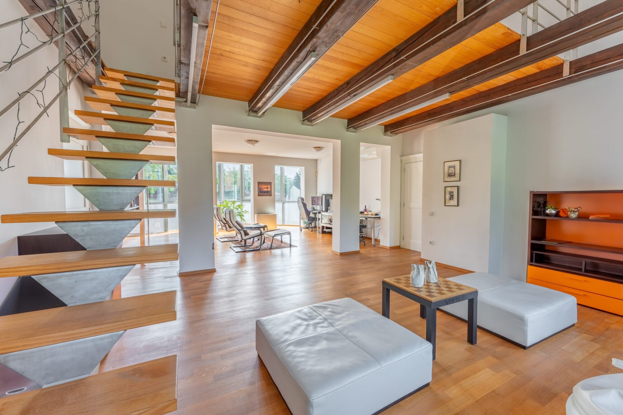 Modern living space with wooden beams and staircase