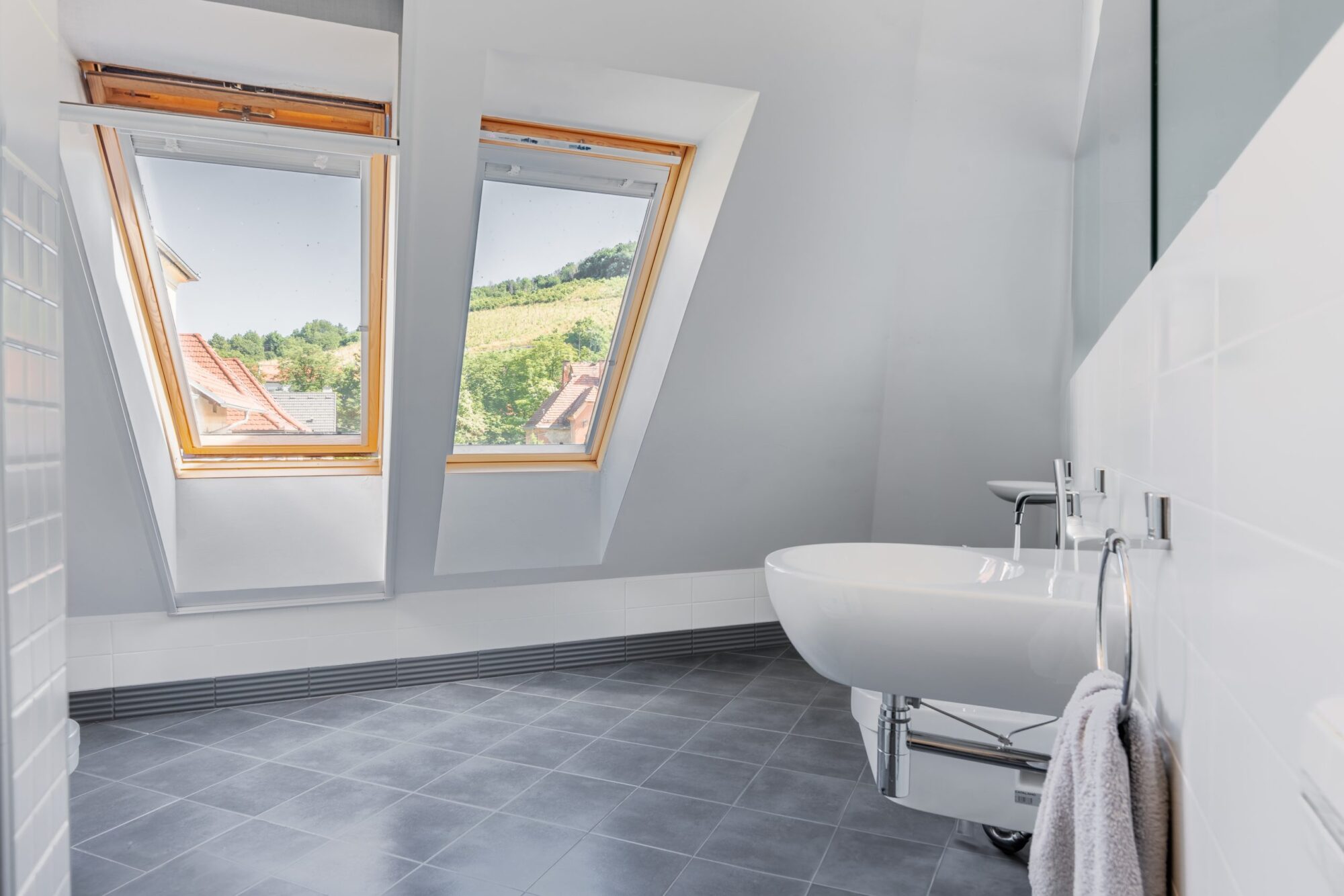 Attic bathroom with skylight windows and sink