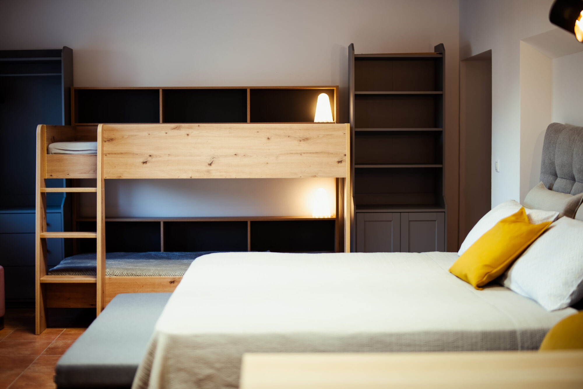 Close-up of bunk bed with bookshelf and lamp