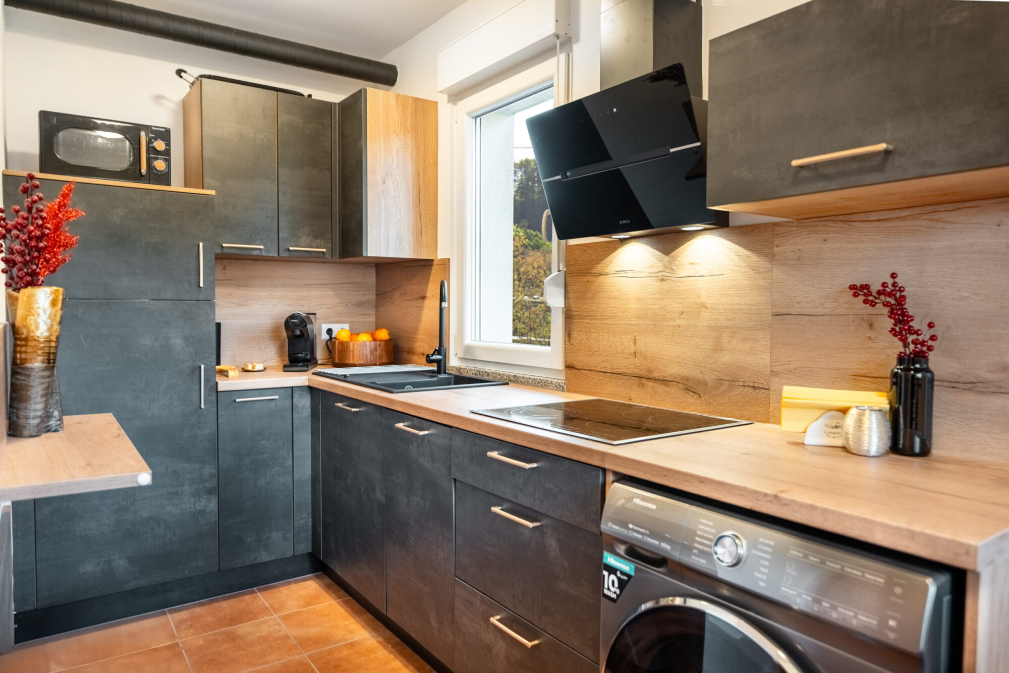 Modern dark kitchen with wood accents and appliances