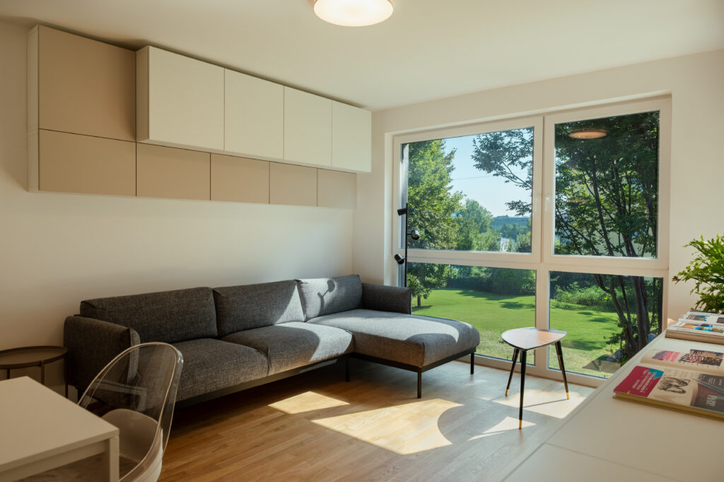 Living room with gray sectional sofa and garden view