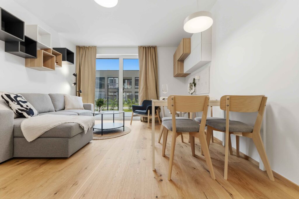 Living room with sofa, dining table and wooden floor