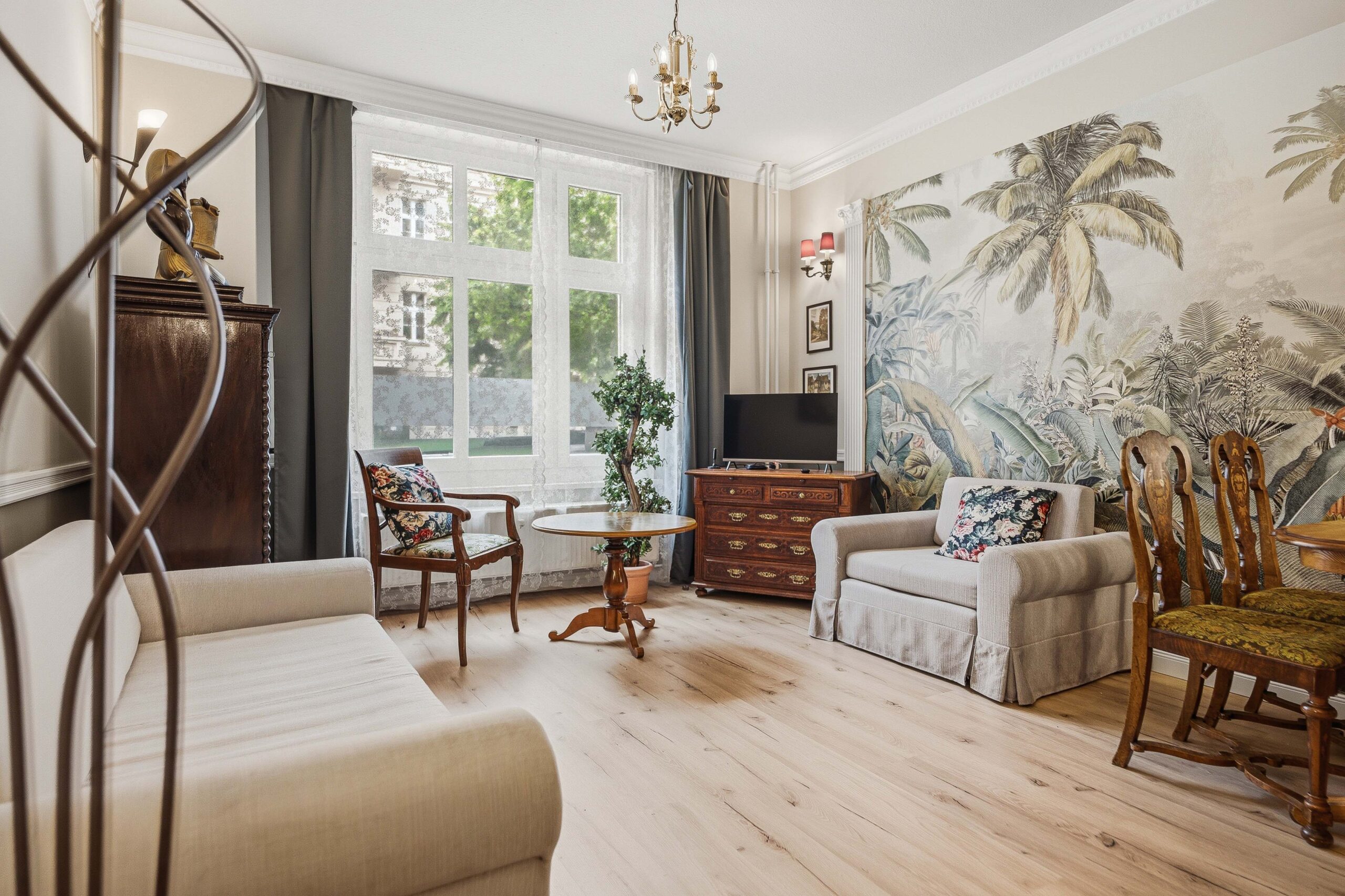 Living room with tropical mural and vintage furniture