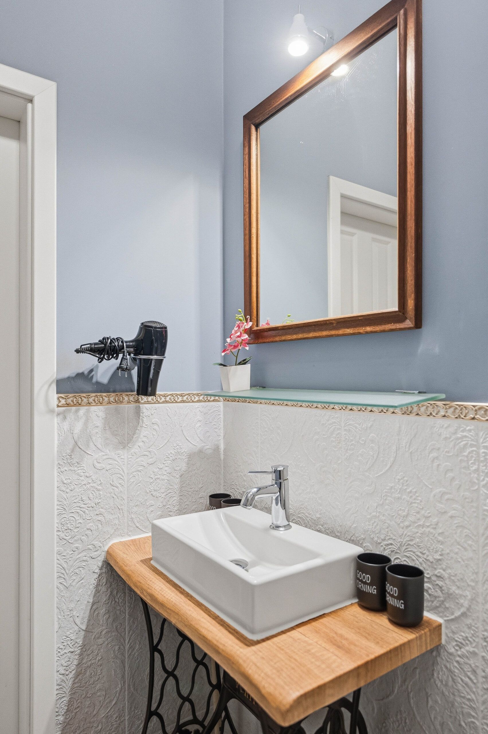 Sink vanity with framed mirror and vintage base