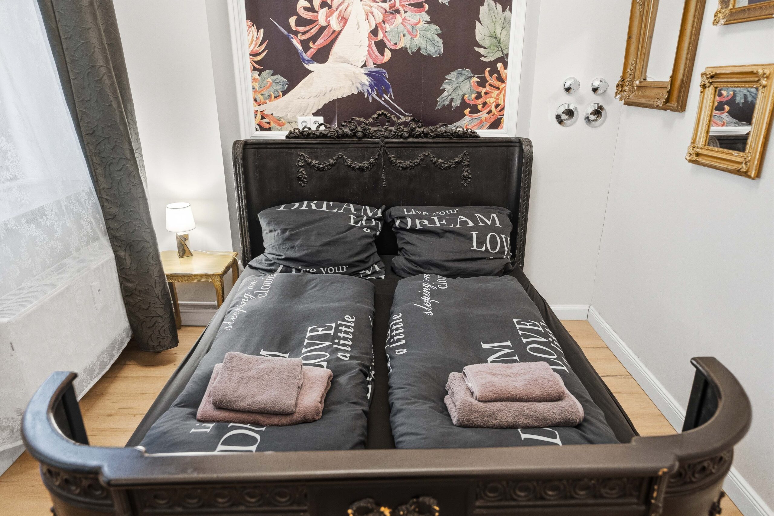 Close view of ornate black bed with pillows