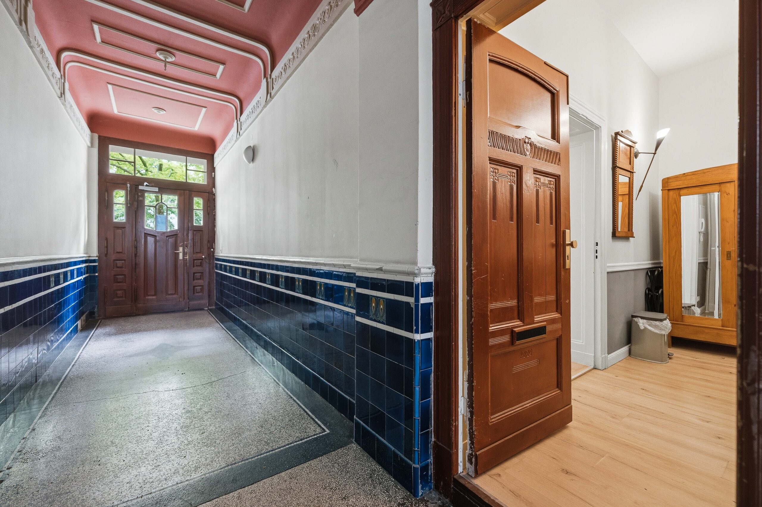 Hallway with ornate doors and tiled flooring