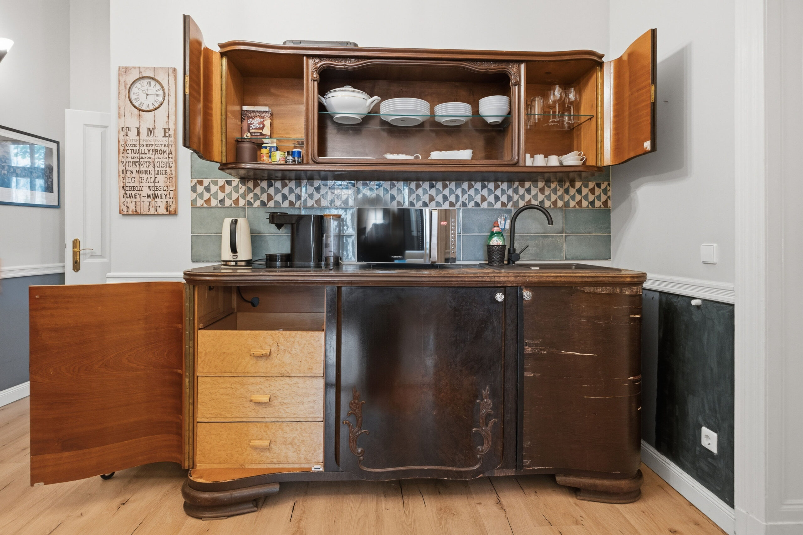 Open vintage cupboard showing dishware storage