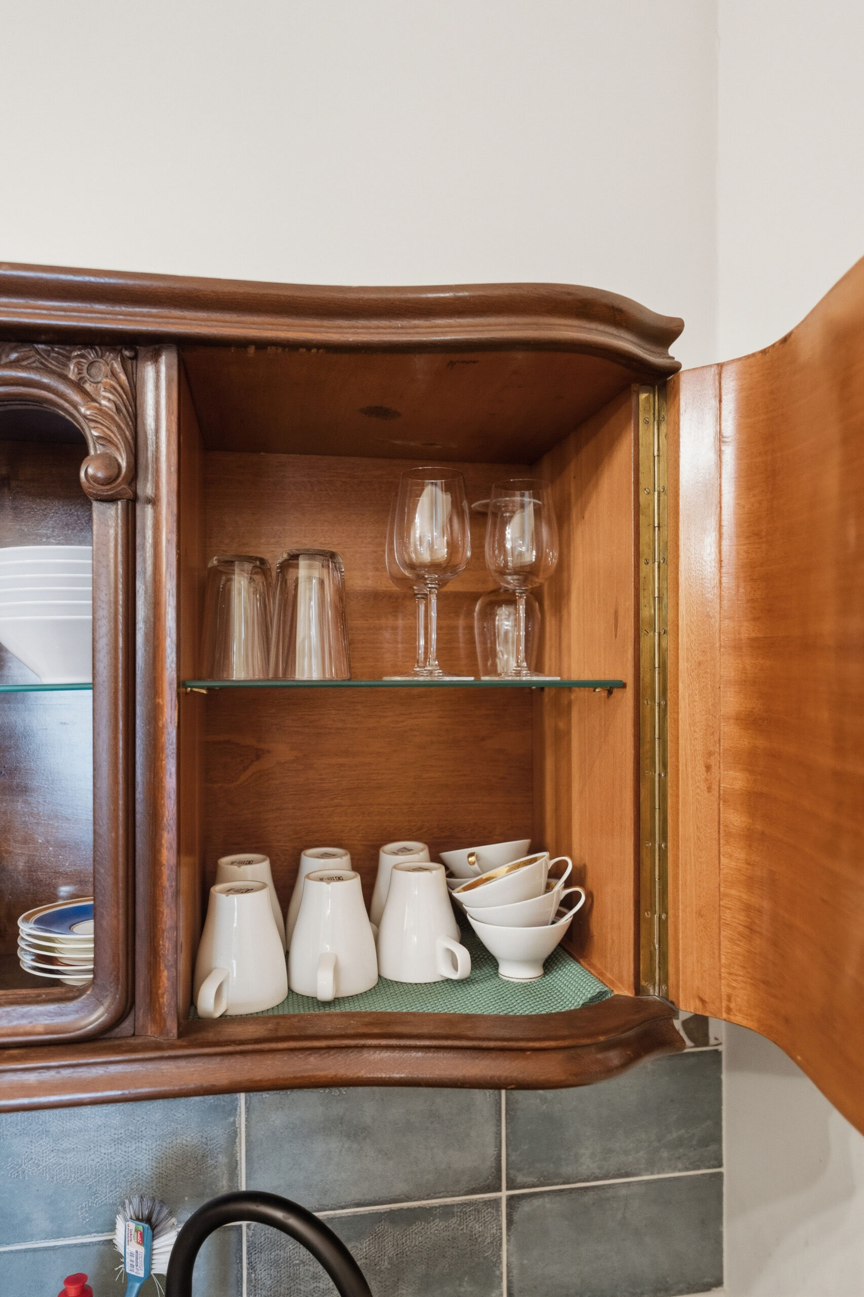 Open cabinet detail with glasses and cups