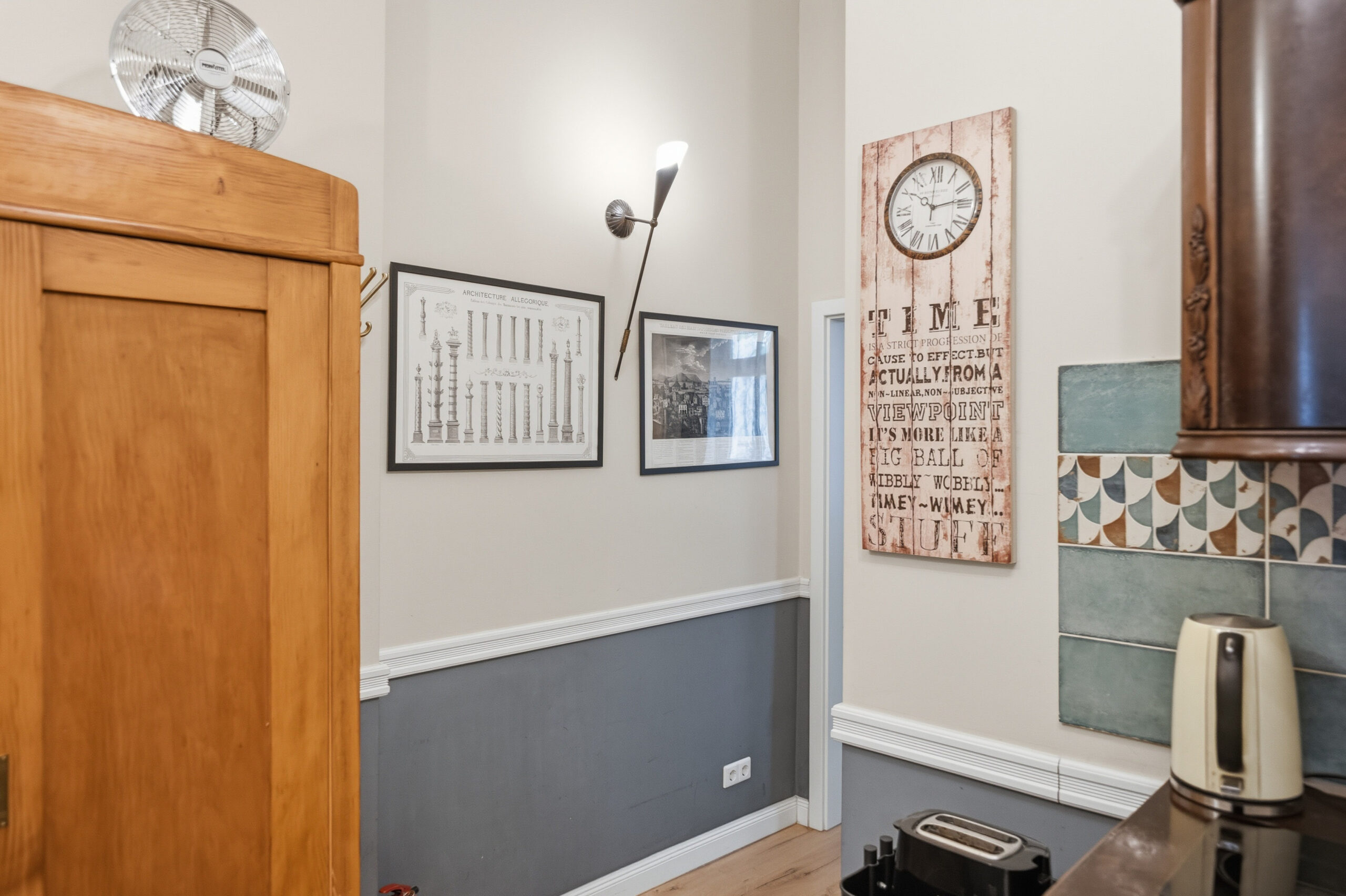 Kitchen entry corner with clock and framed art