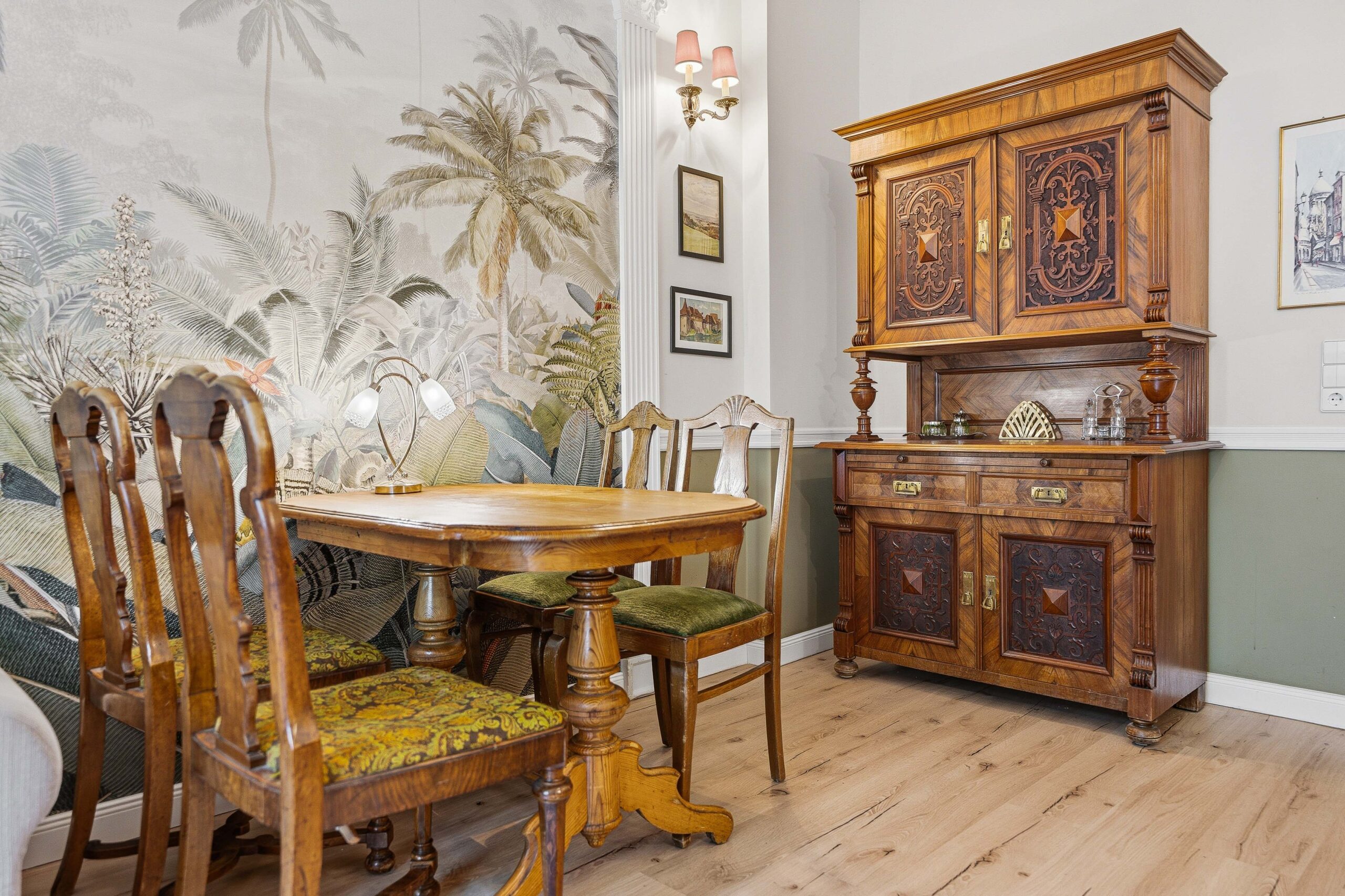 Dining table and chairs by tropical mural wall