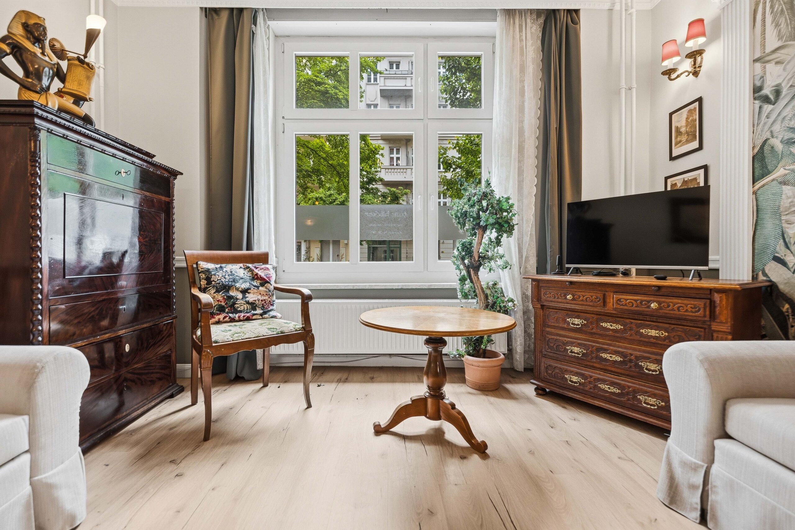 Living room with antique dresser and round table