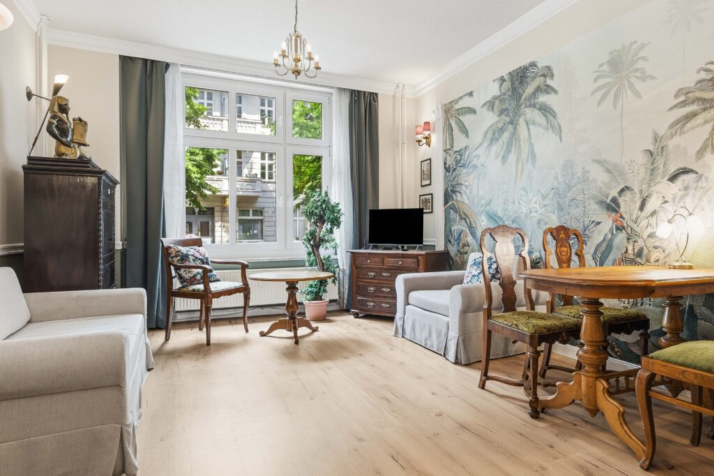 Living room with palm mural, sofa and dining table