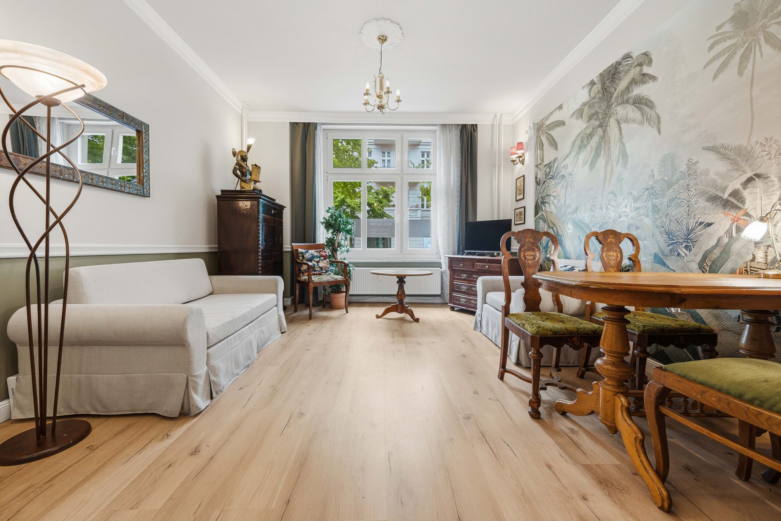 Wide living room view with mural and dining set