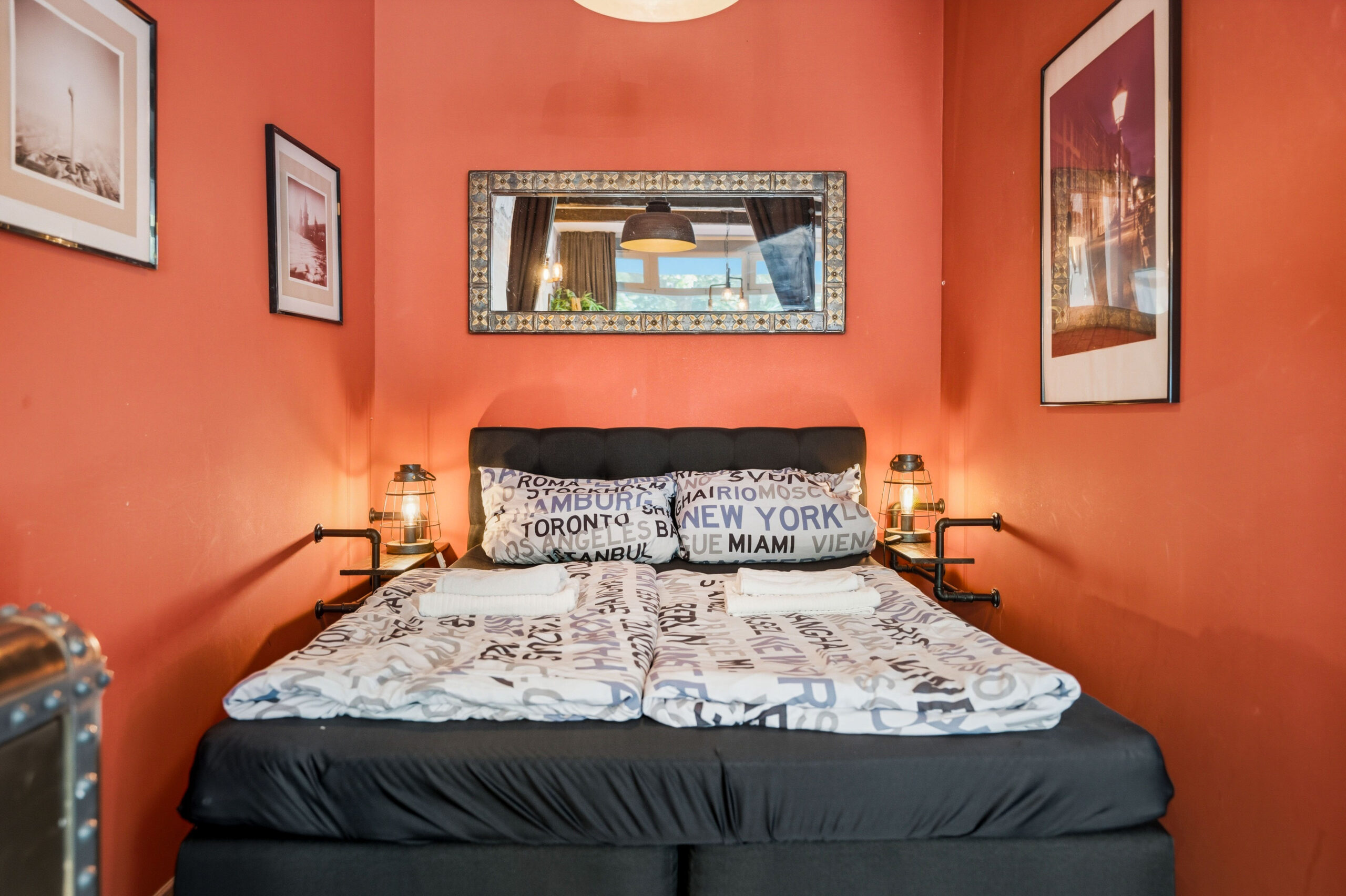 Cozy bedroom with patterned bedding and orange walls