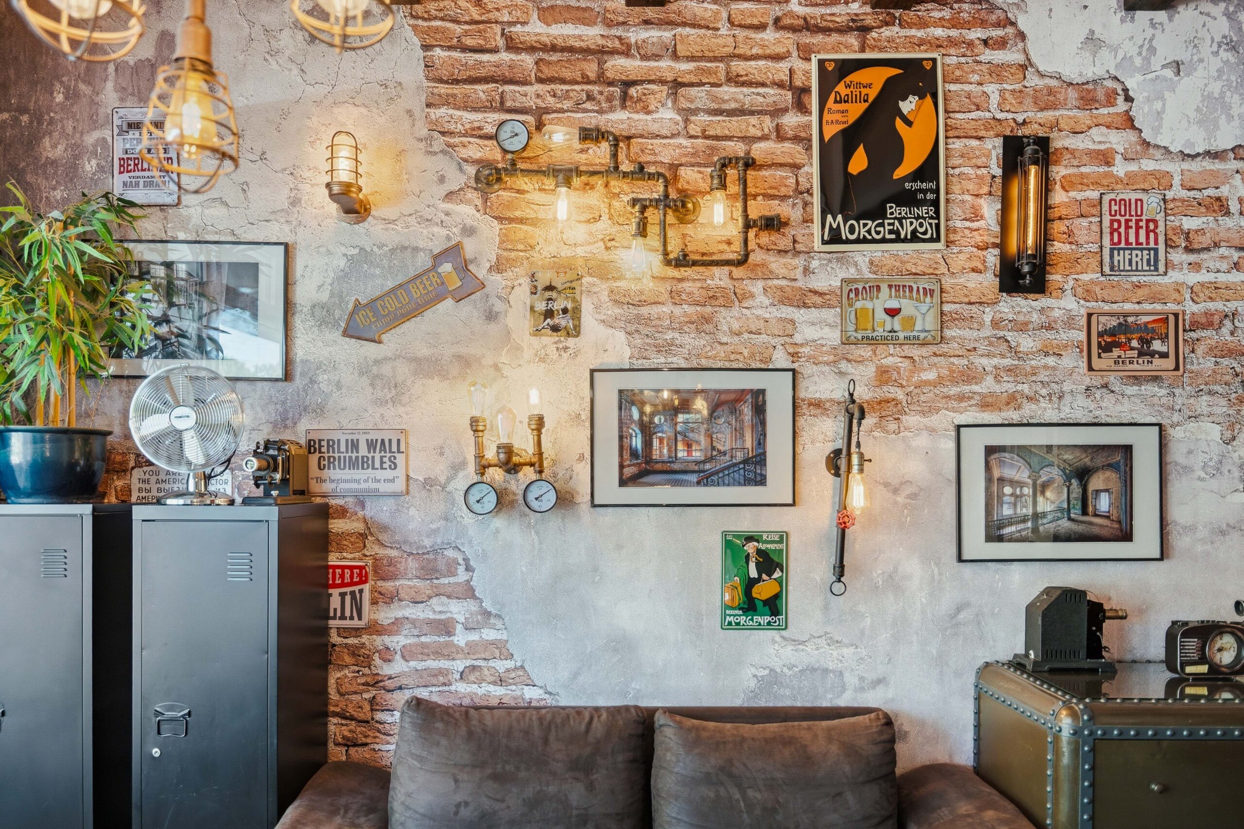 Brick wall decorated with lights and framed photos