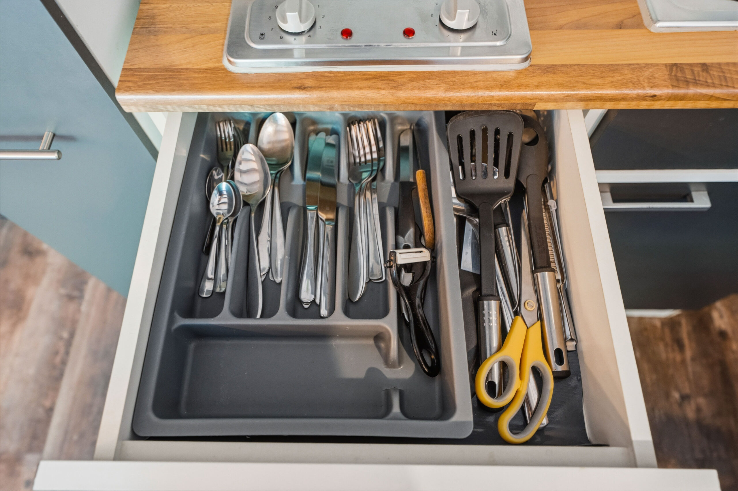 Drawer with organized cutlery and kitchen tools
