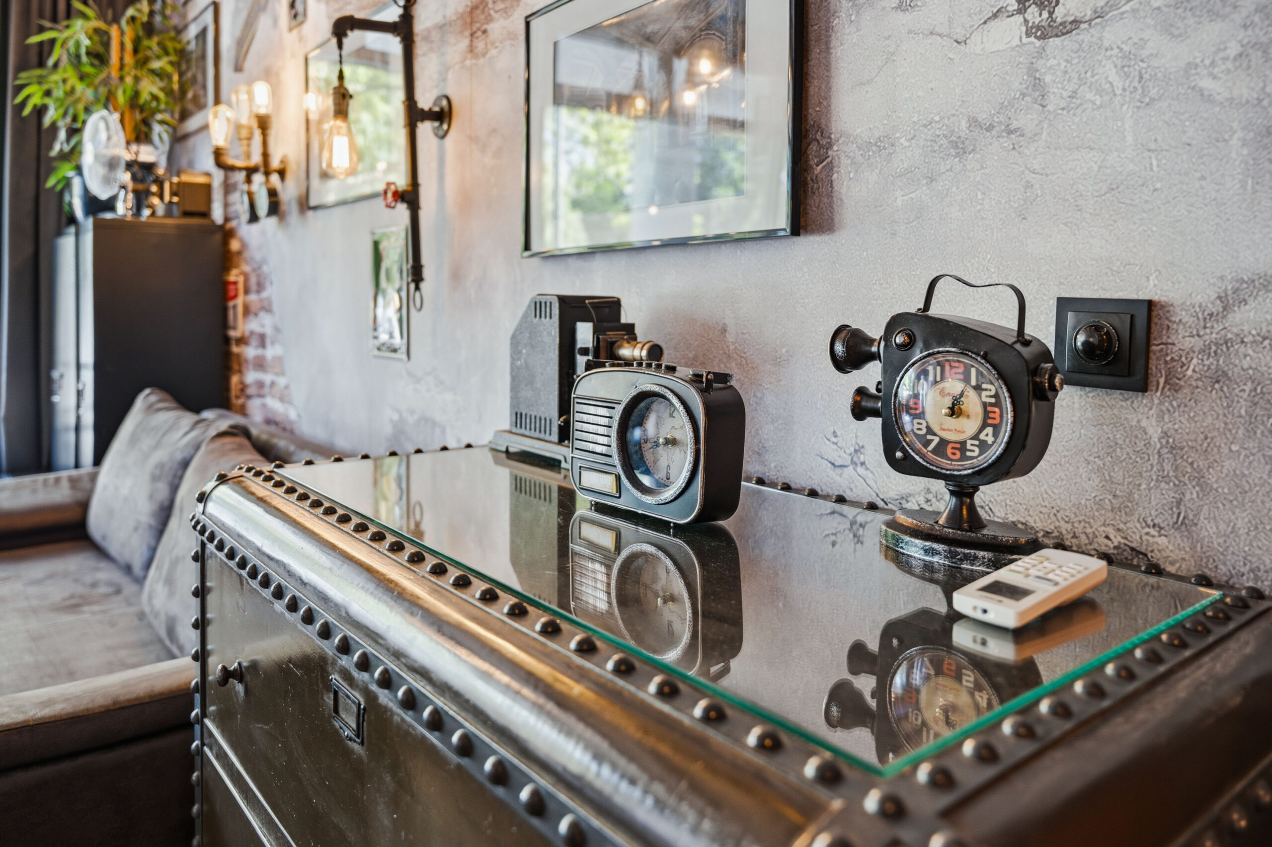 Vintage clocks displayed on metal trunk table