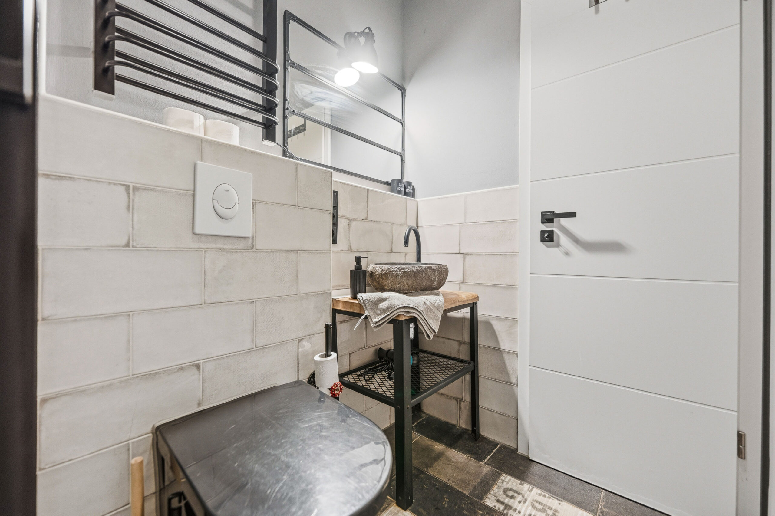 Bathroom corner with stone sink and mirror