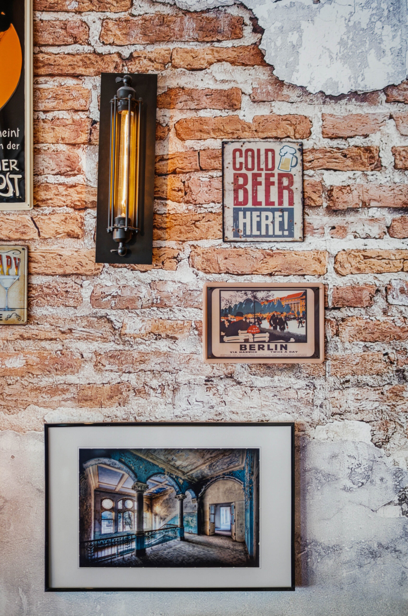 Exposed brick wall with vintage signs and framed art