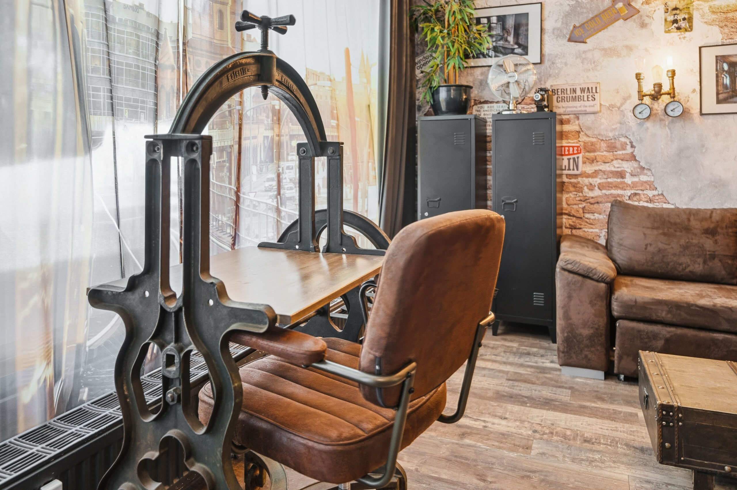 Industrial style chair and vintage desk by window