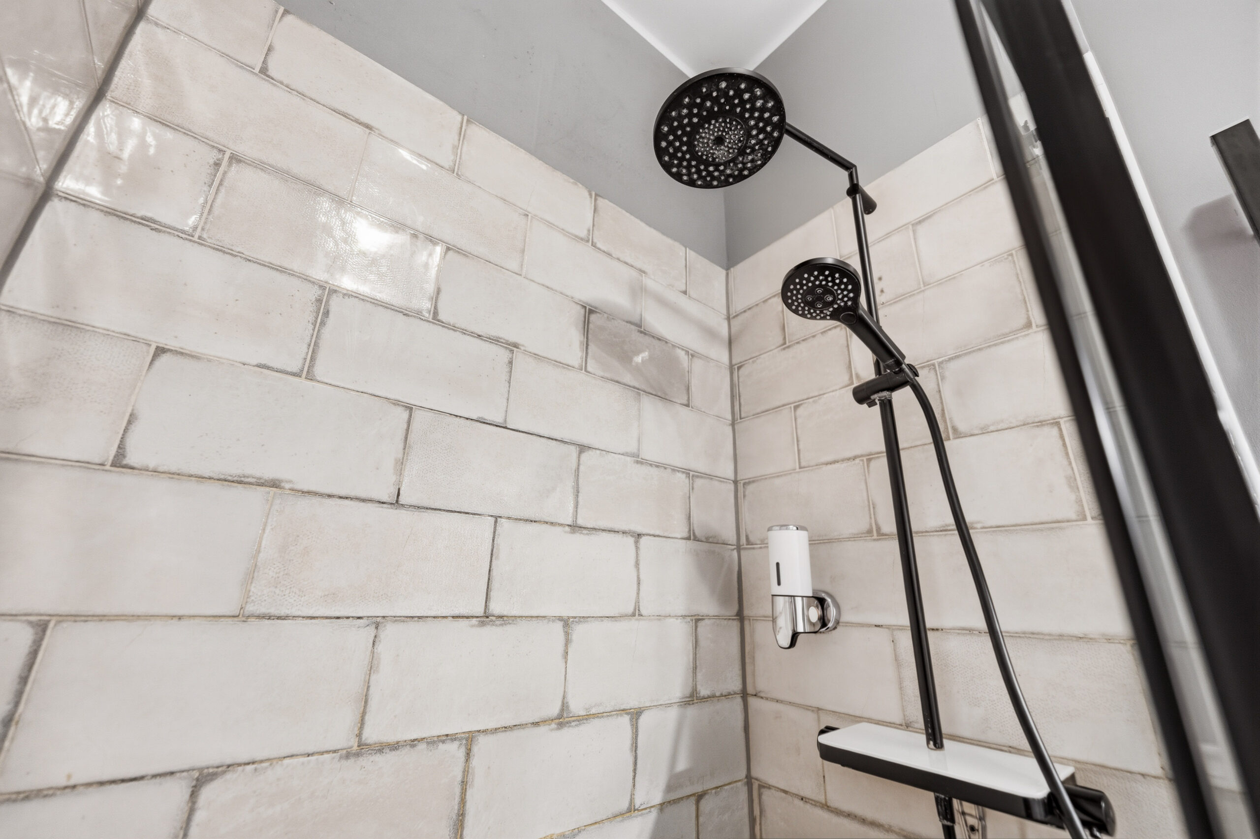 Shower area with tiled wall and rainfall showerhead