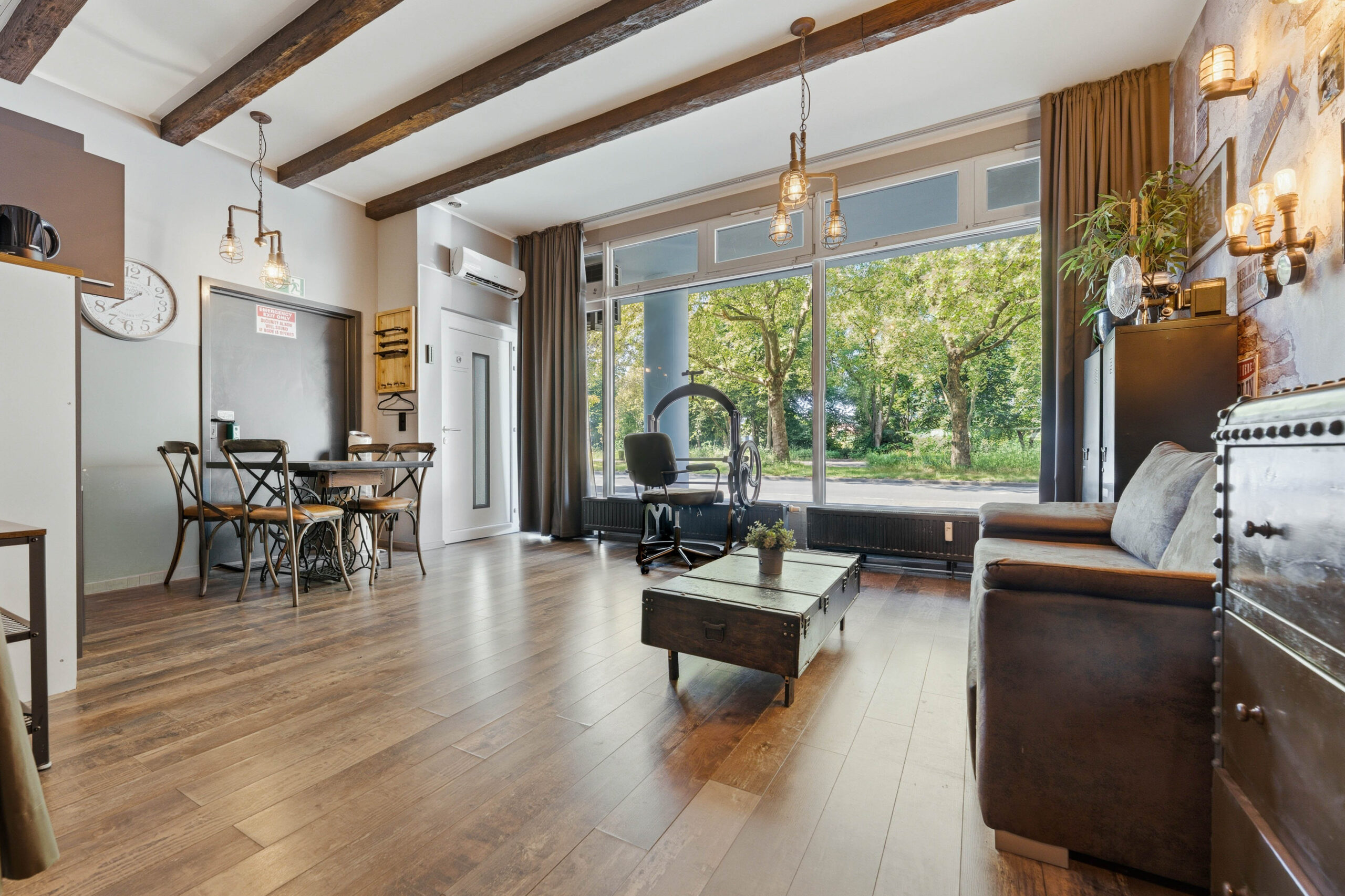 Living room with large window and wooden beams