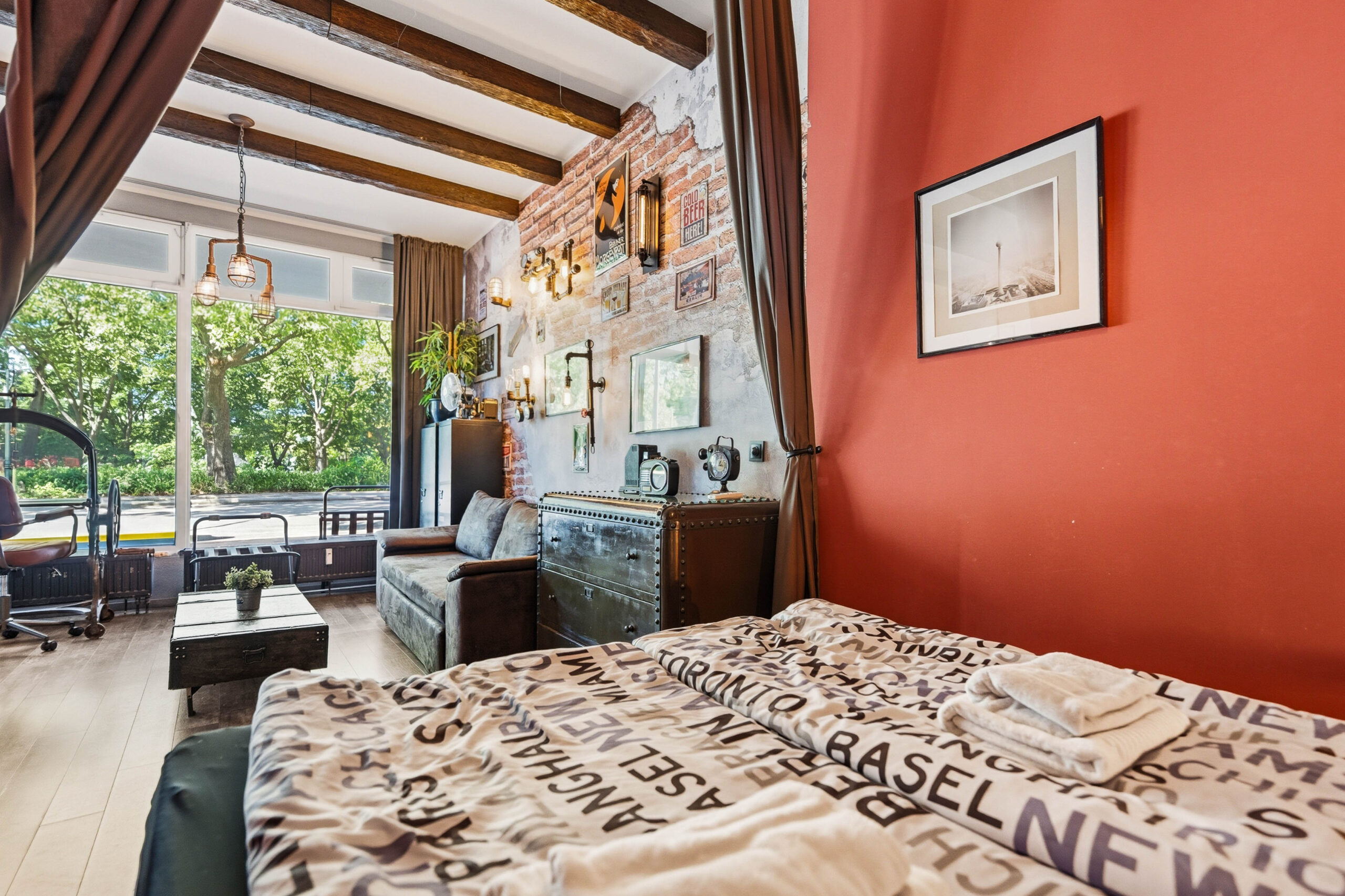 Bedroom with orange wall and view to living area