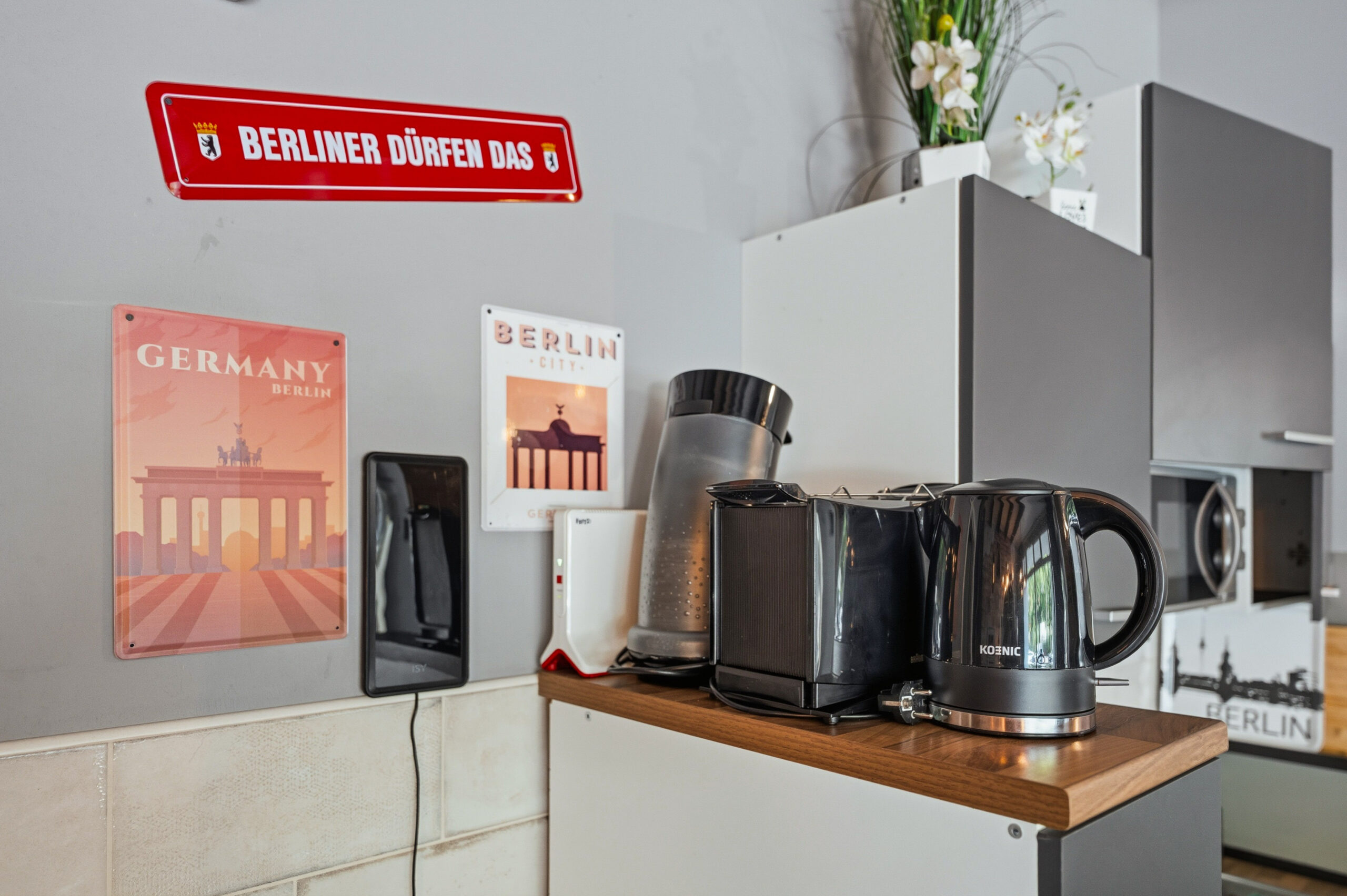 Kitchen counter with kettle, coffee maker and decor