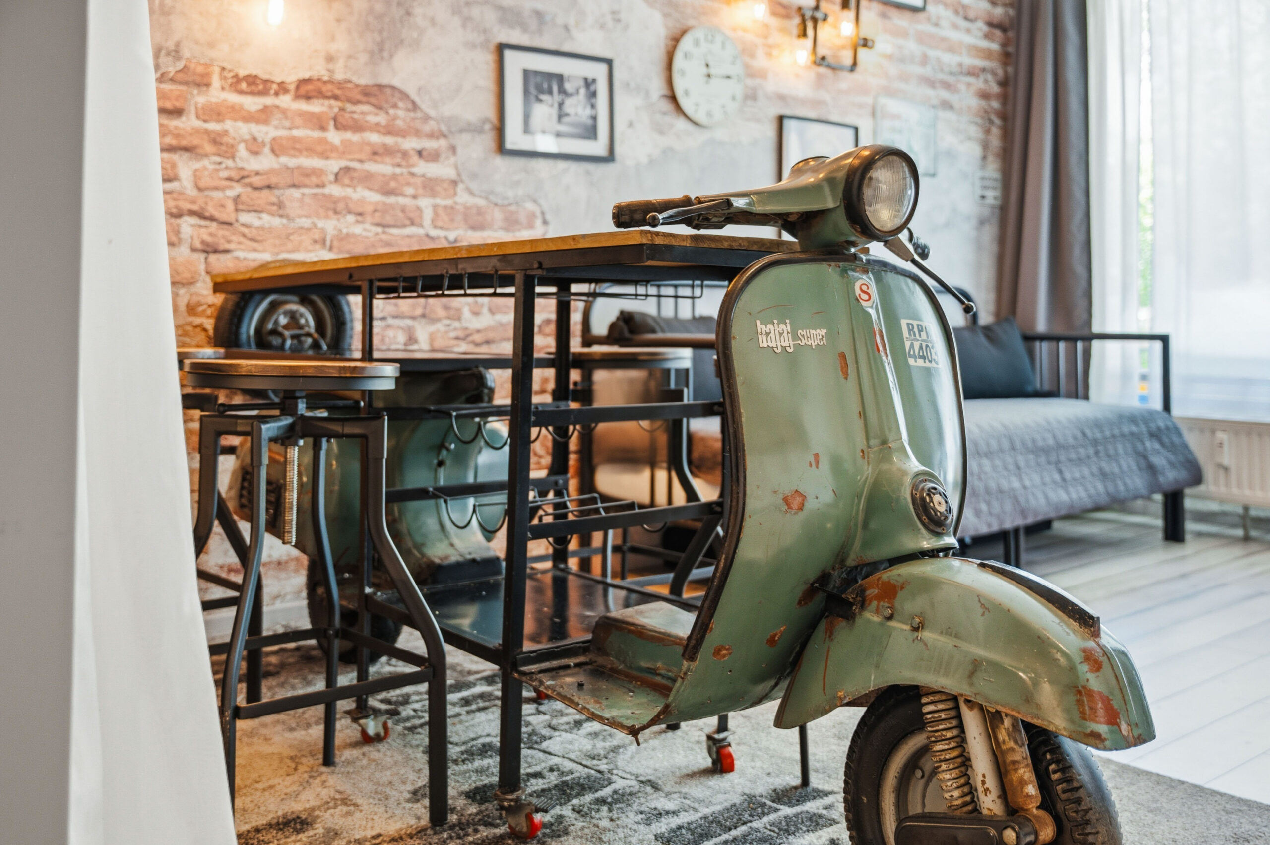 Close-up of vintage green scooter under dining table