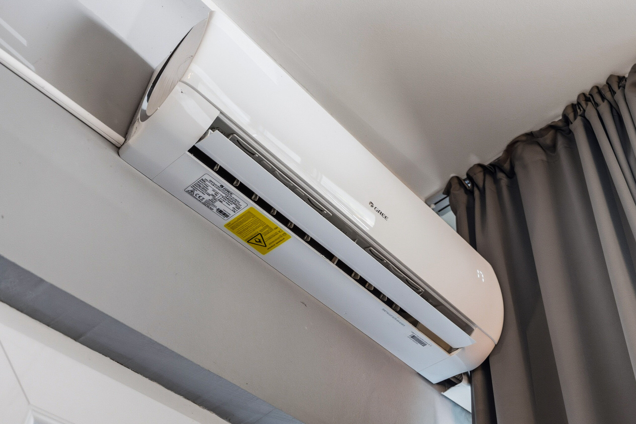 Wall-mounted air conditioning unit near window