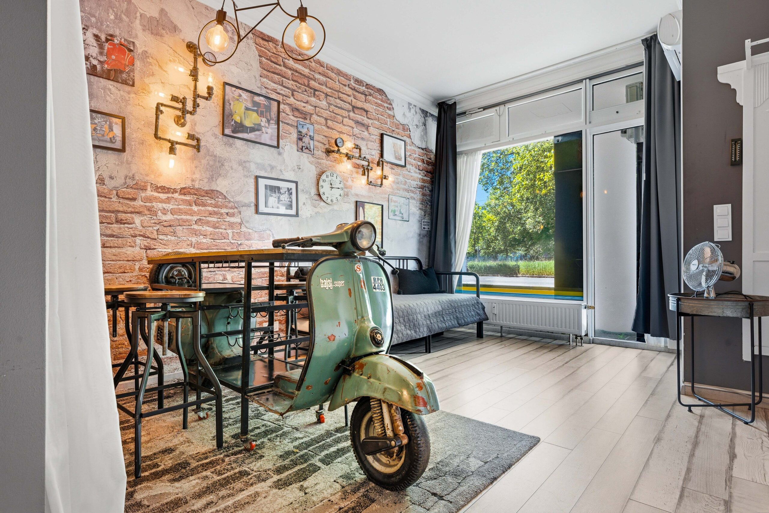 Eclectic living room with vintage scooter and brick wall