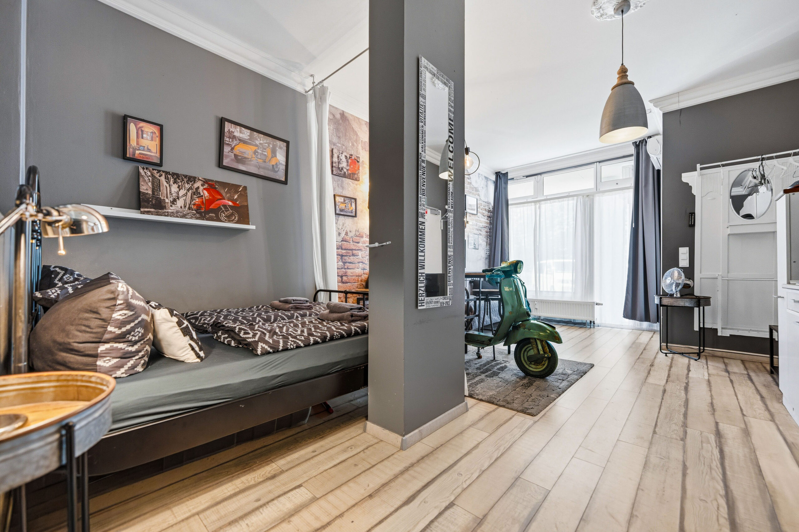 Bedroom with daybed and scooter visible in hallway