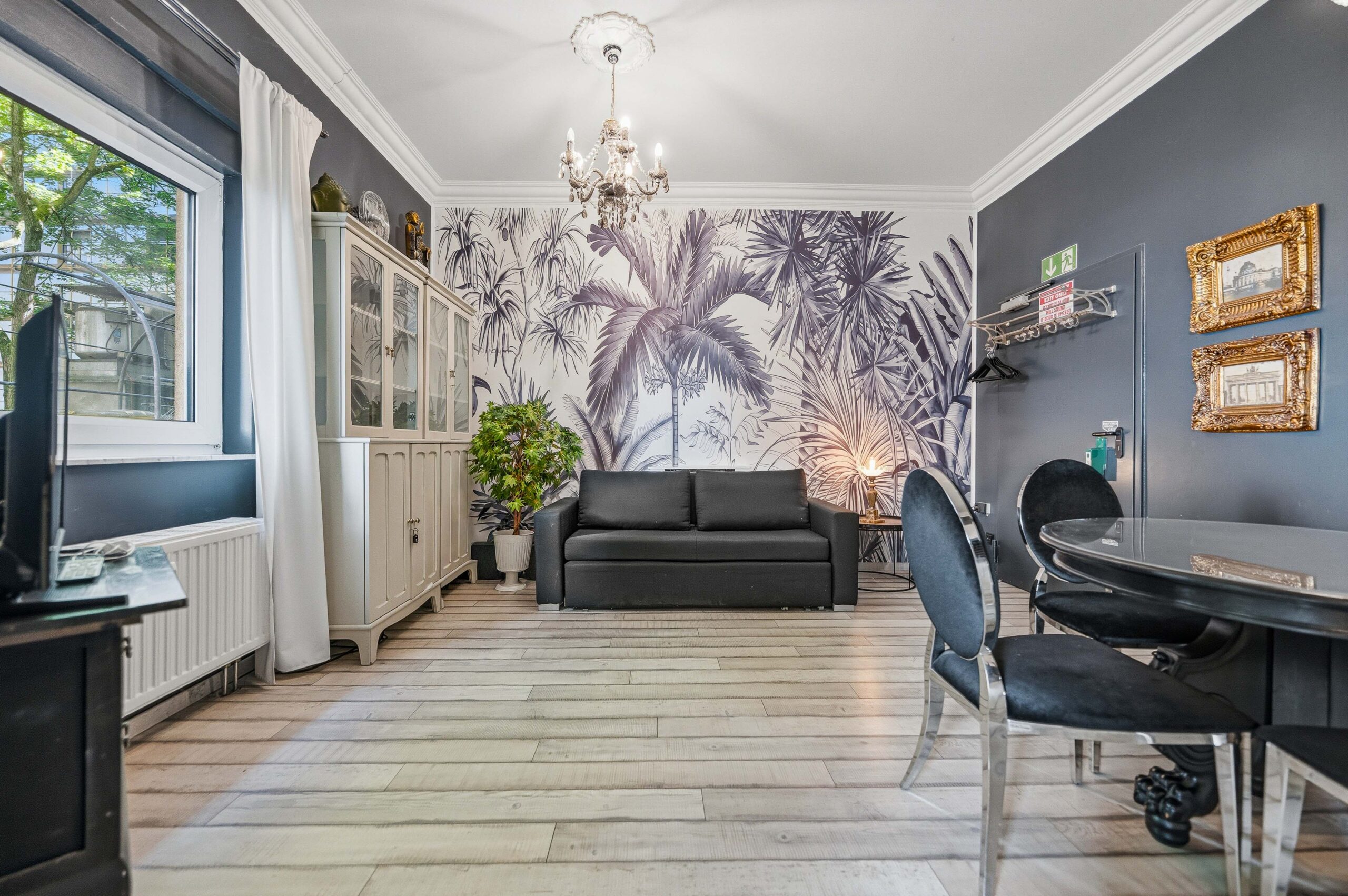 Living room with mural wall and chandelier