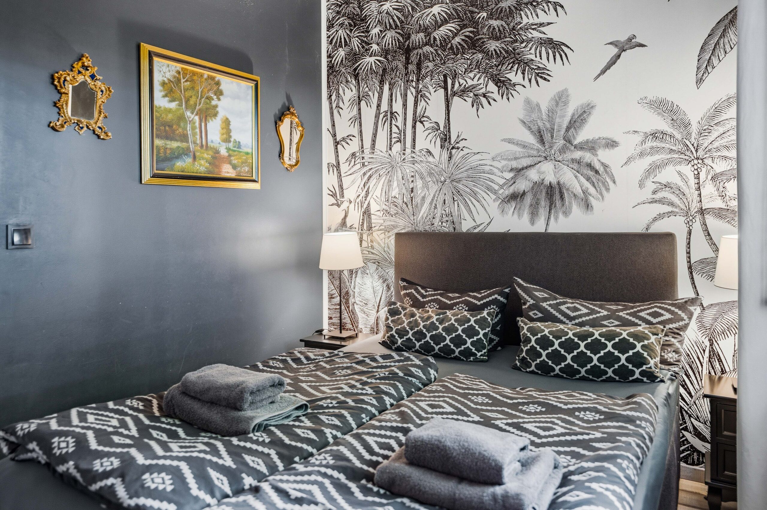 Bedroom with framed art and patterned bedding