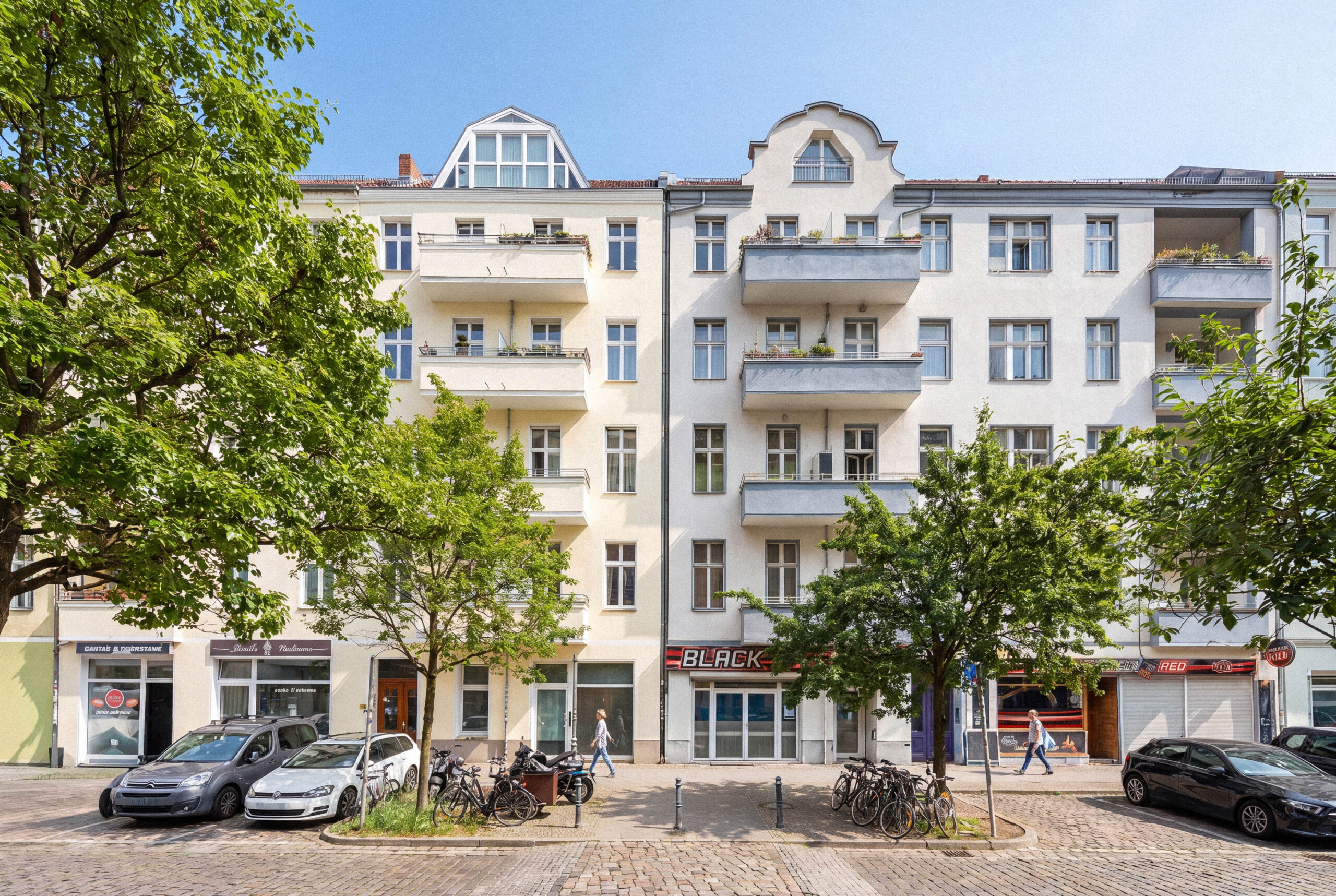 Modern apartment building facade with street-level retail entrance
