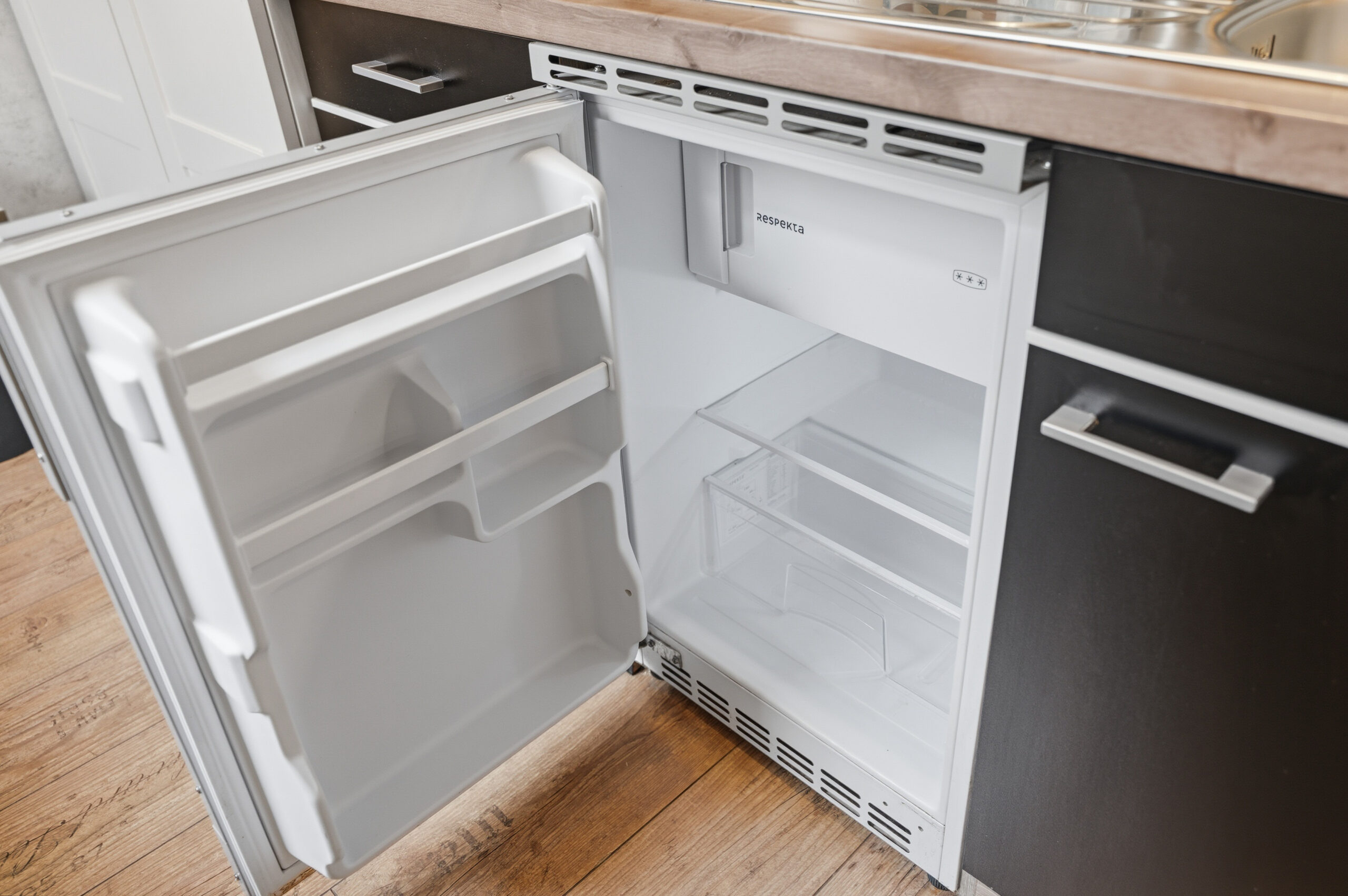 Small built-in refrigerator and kitchenette workspace