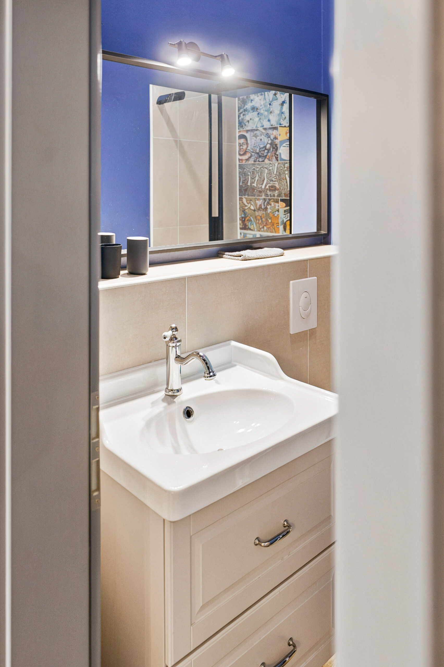 Compact bathroom with mirror, sink, and blue window