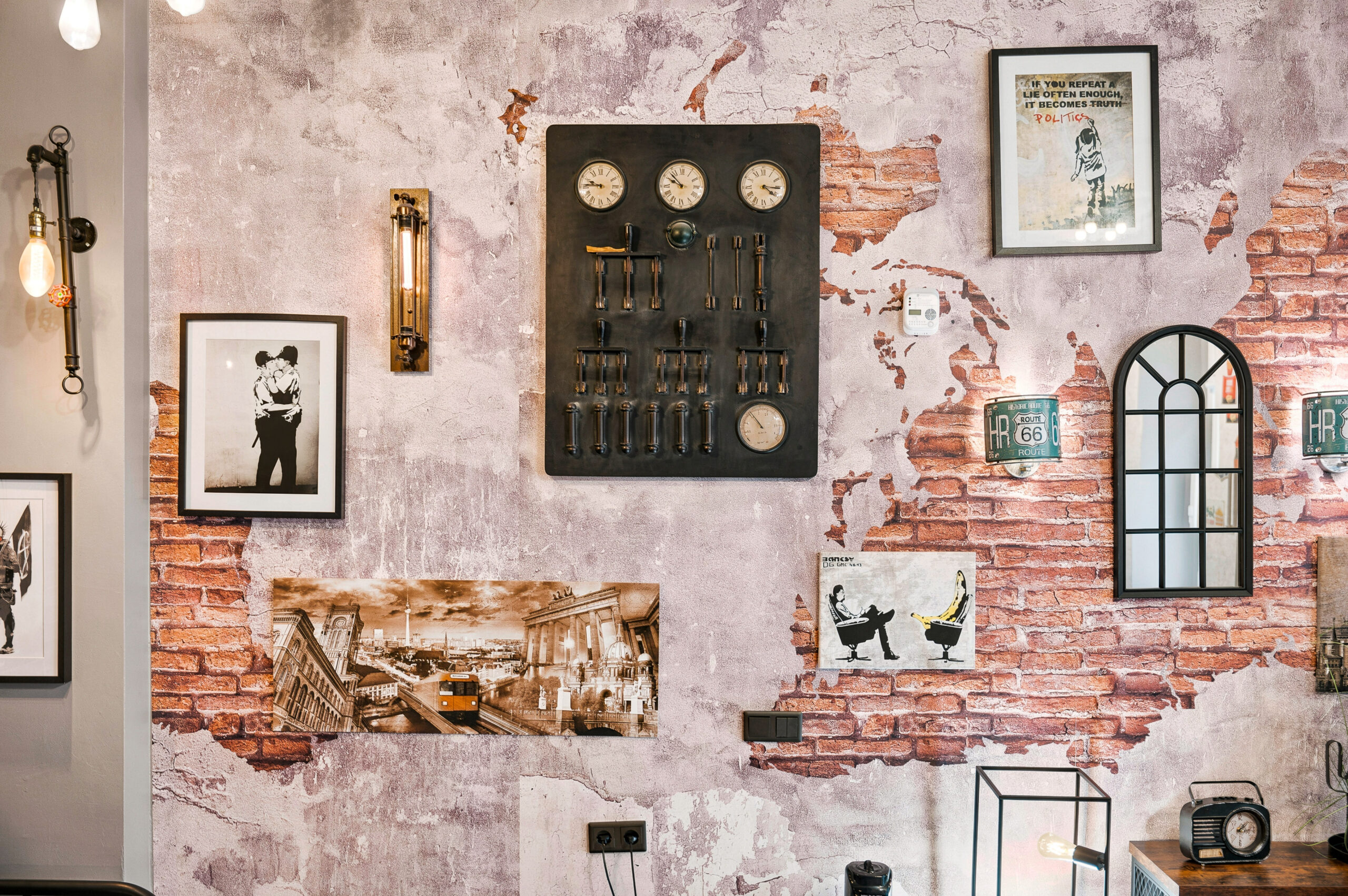 Exposed brick wall with framed art and control panel