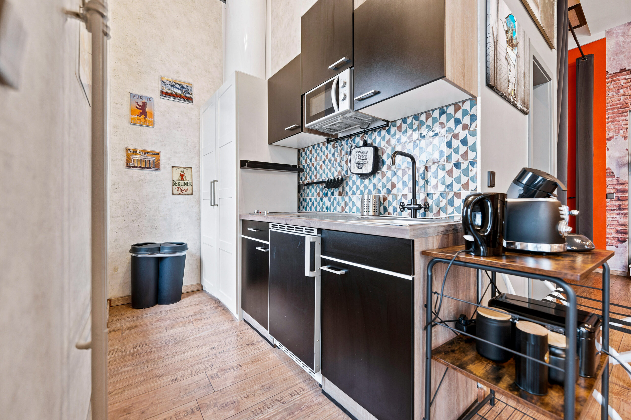 Small kitchen with dark cabinets and geometric tiles