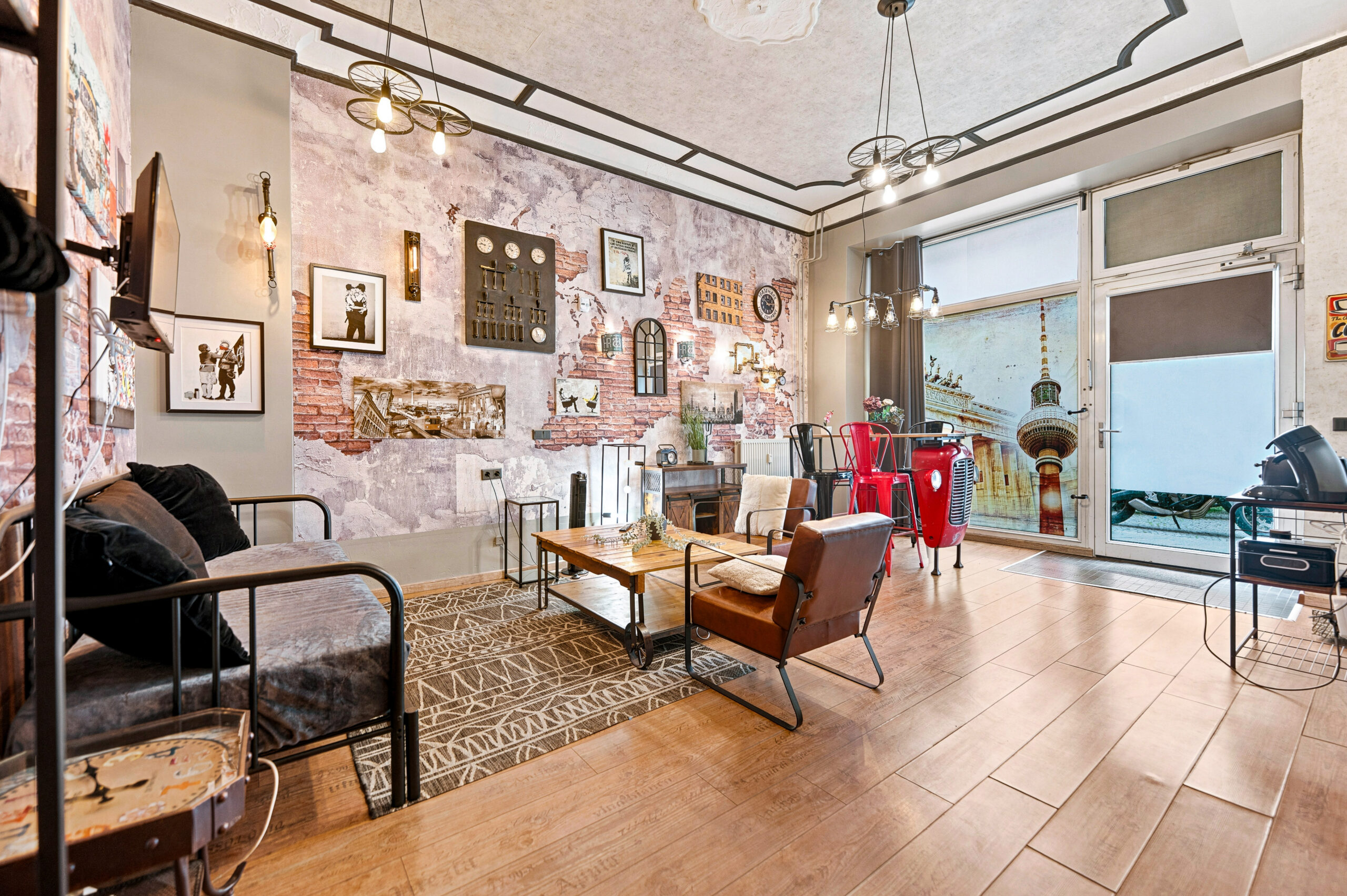 Bright studio with large window, sofa, exposed brick walls