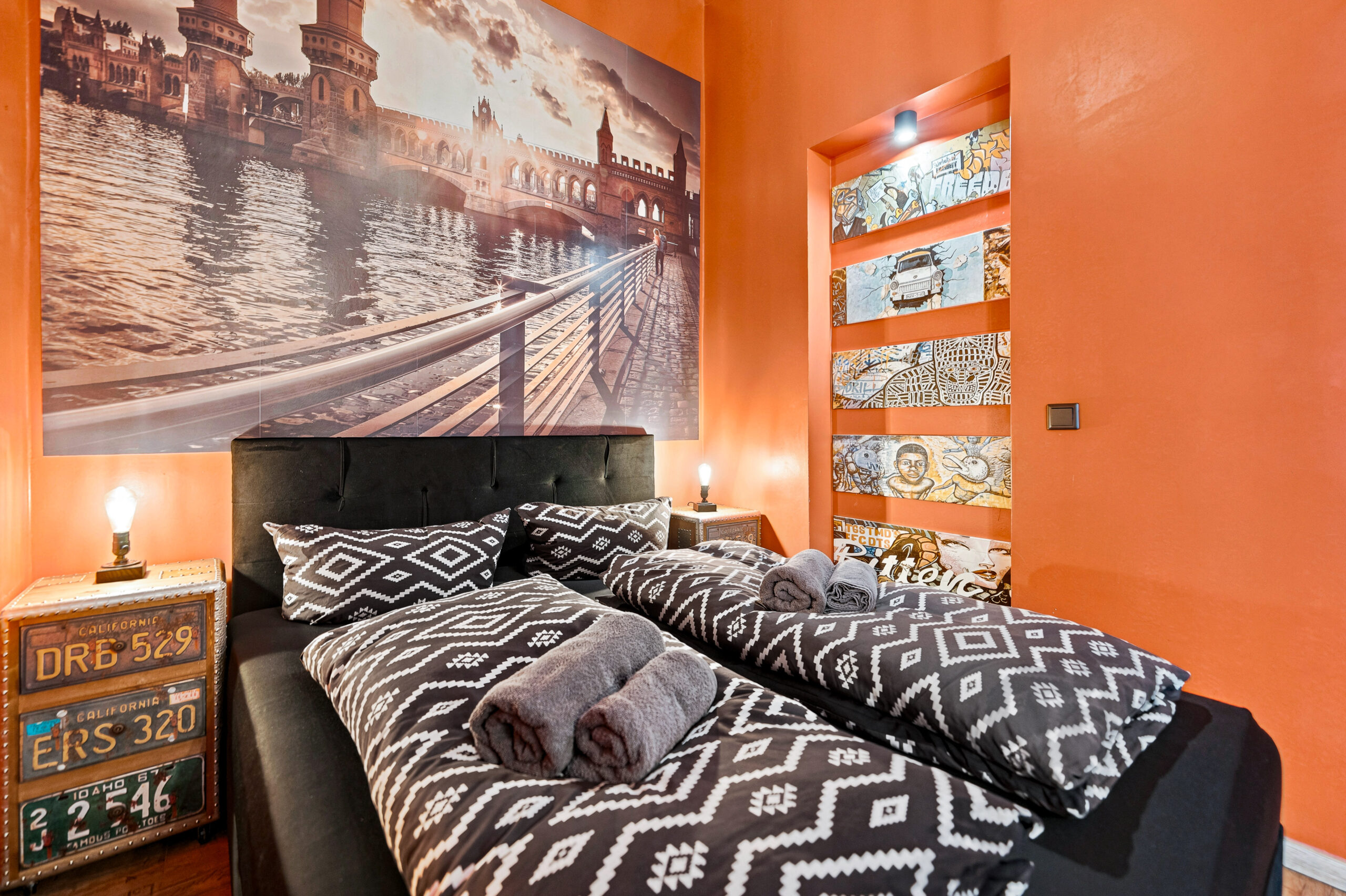 Orange bedroom with geometric patterned duvet and orange shelving