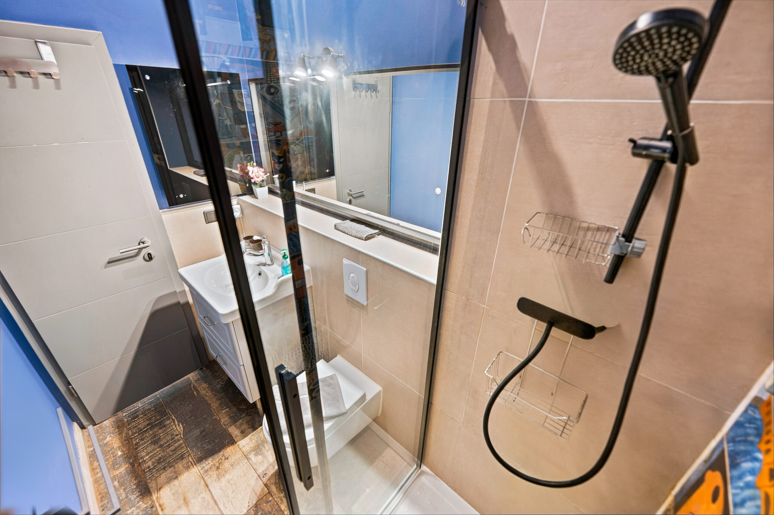 Modern shower enclosure with rainfall head and white tiles