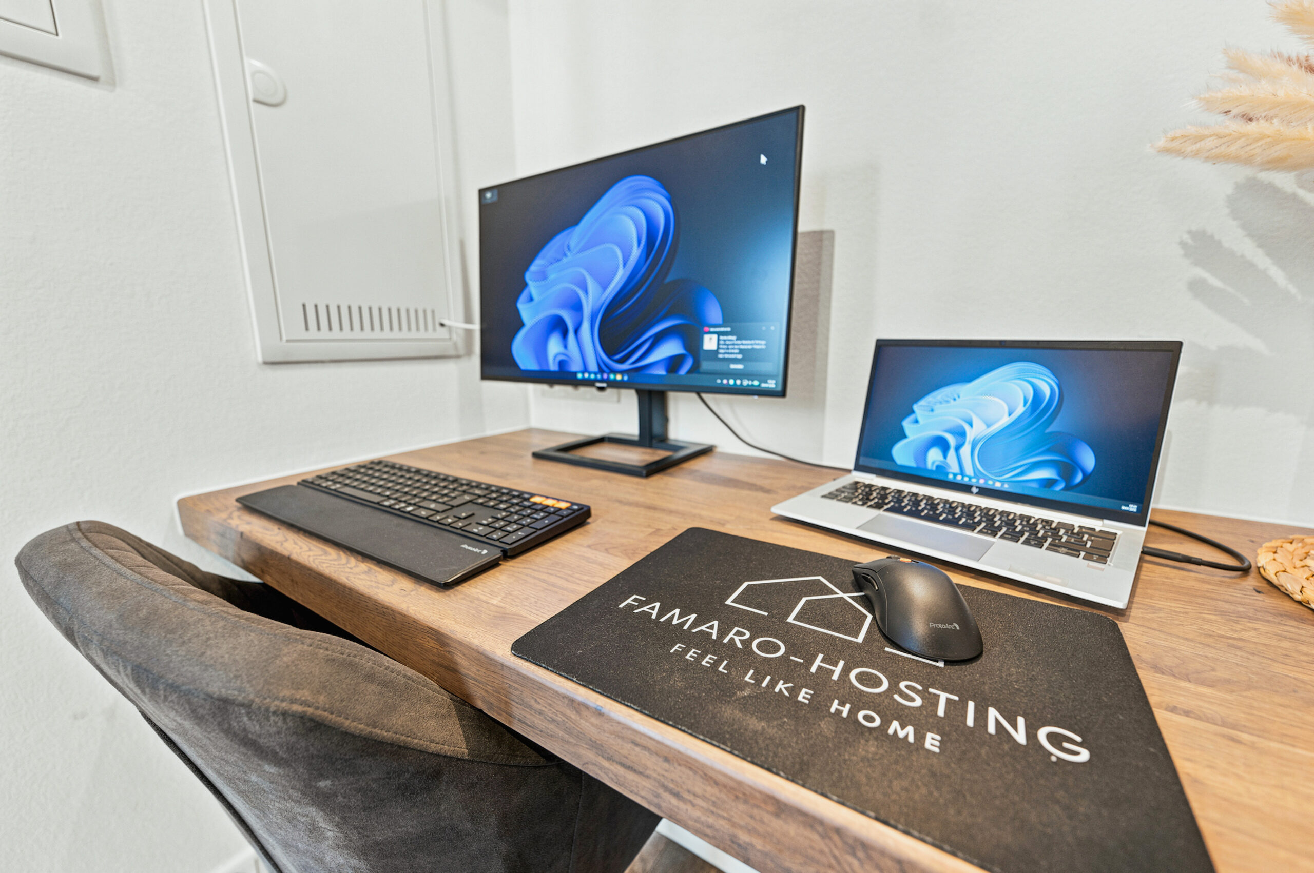 Workspace desk with two monitors and wooden surface
