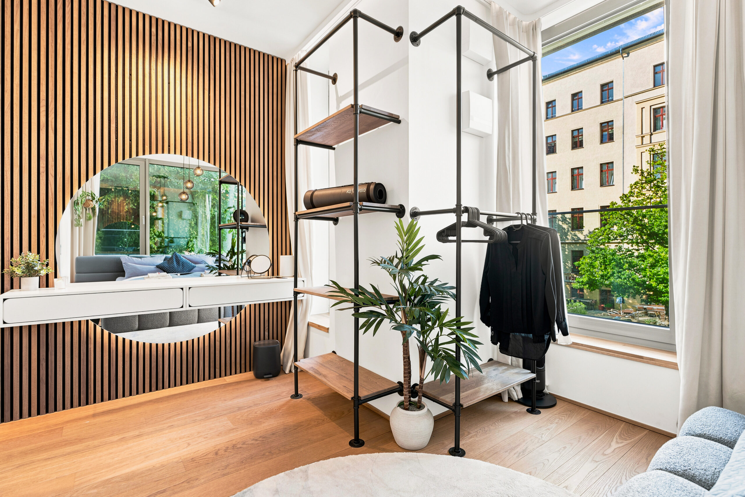 Modern bedroom with wooden accent wall and urban view